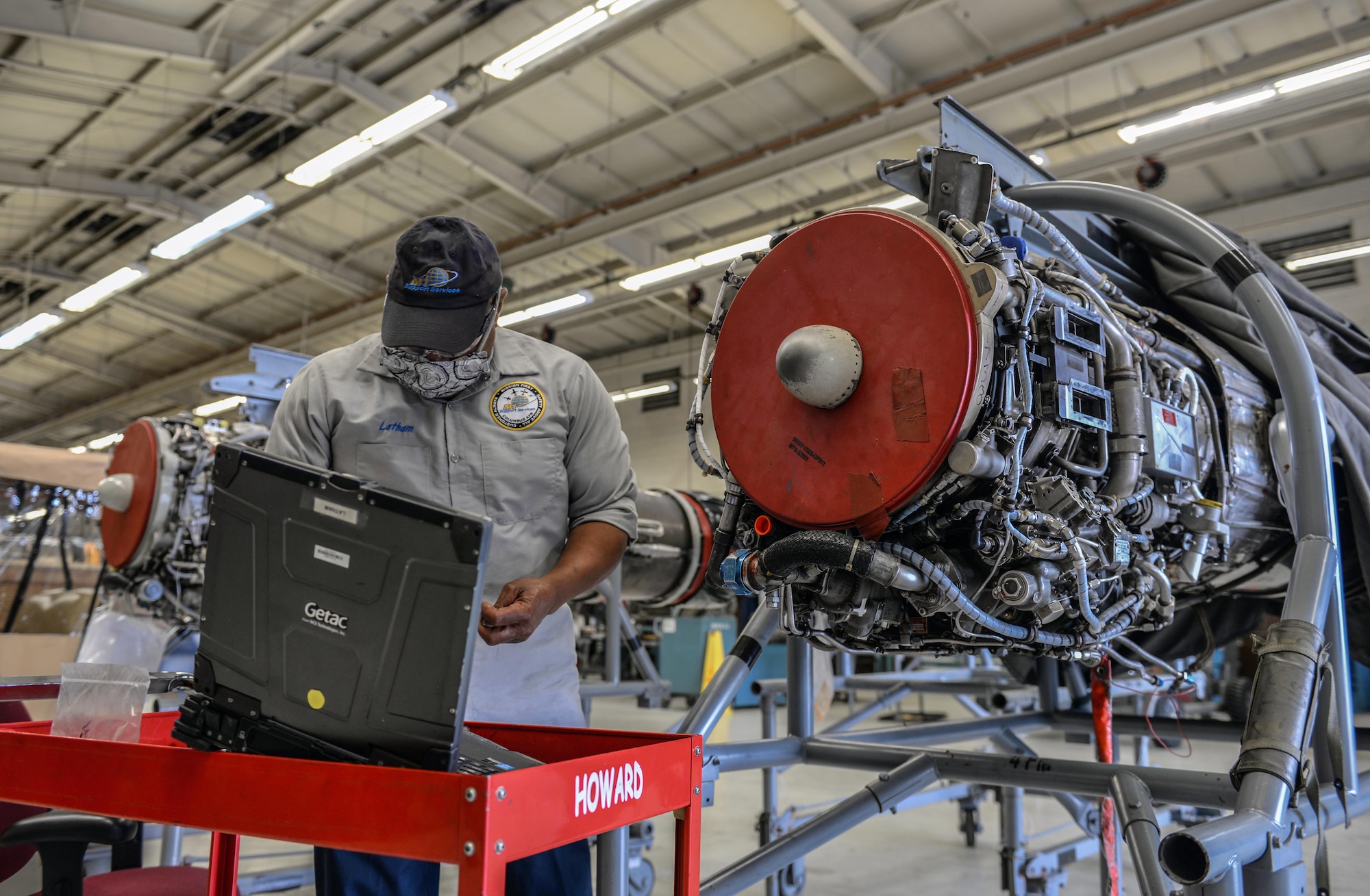 Willy Latham, M1 Support Services propulsion mechanic, gathers tools in order to perform maintenance on a General Electric J85-GE-5 turbojet engine April 17, 2020, at Columbus Air Force Base, Miss. The T-38 Talon is equipped with two General Electric J85-GE-5 turbojet engines. (U.S. Air Force photo by Airman 1st Class Davis Donaldson)