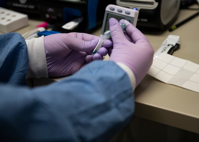 Airman 1st Class Miranda Bateman prepares a rapid strep test.