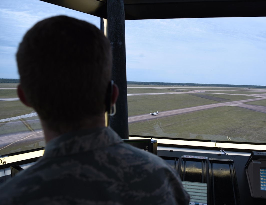 Senior Airman James McMillan, 14th Operations Support Squadron Air Traffic controller, watches a T-6 Texan II taxi out from the Control tower April 22, 2020, on Columbus Air Force Base, Miss. Columbus AFB is one of the busiest bases for Air Traffic Controllers with the average upgrade training time for Tower trainees being ten months and for RAPCON trainees is one year. (U.S. Air Force photo by Airman 1st Class Jake Jacobsen)