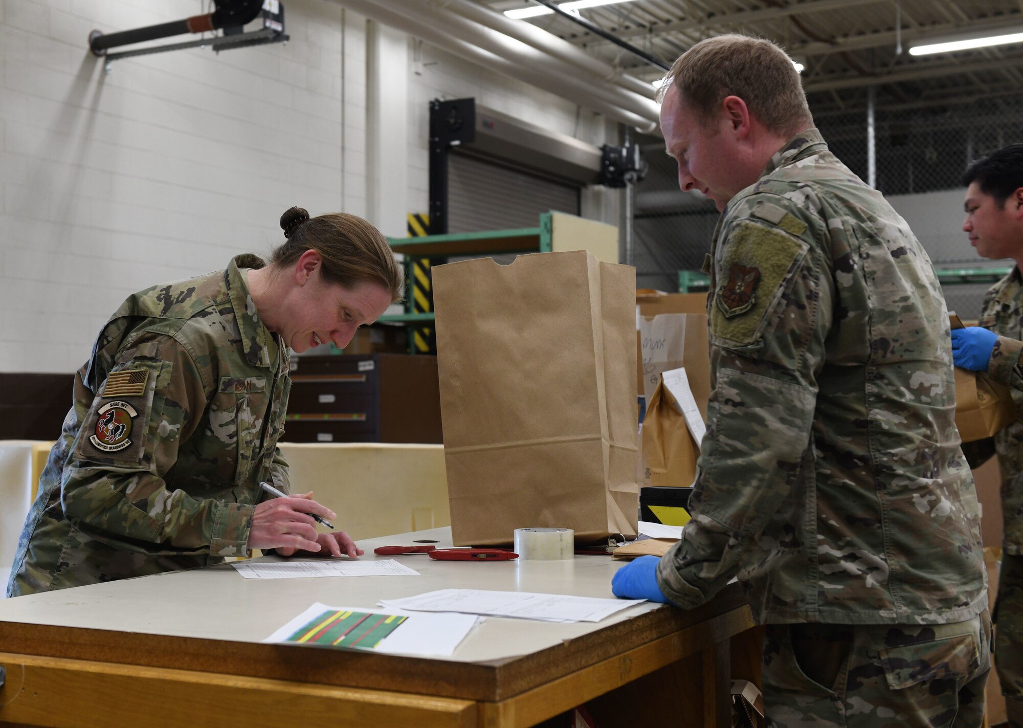 Maj. Saira McGan, the 28th Logistics Readiness operations officer, procures face masks for her squadron at the Flight Service Center on Ellsworth Air Force Base., April 21, 2020. The 28th Contracting Squadron ordered 7,300 face masks for base dissemination, in an effort to battle the COVID-19 pandemic. (U.S. Air Force photo by Airman 1st Class Christina Bennett)