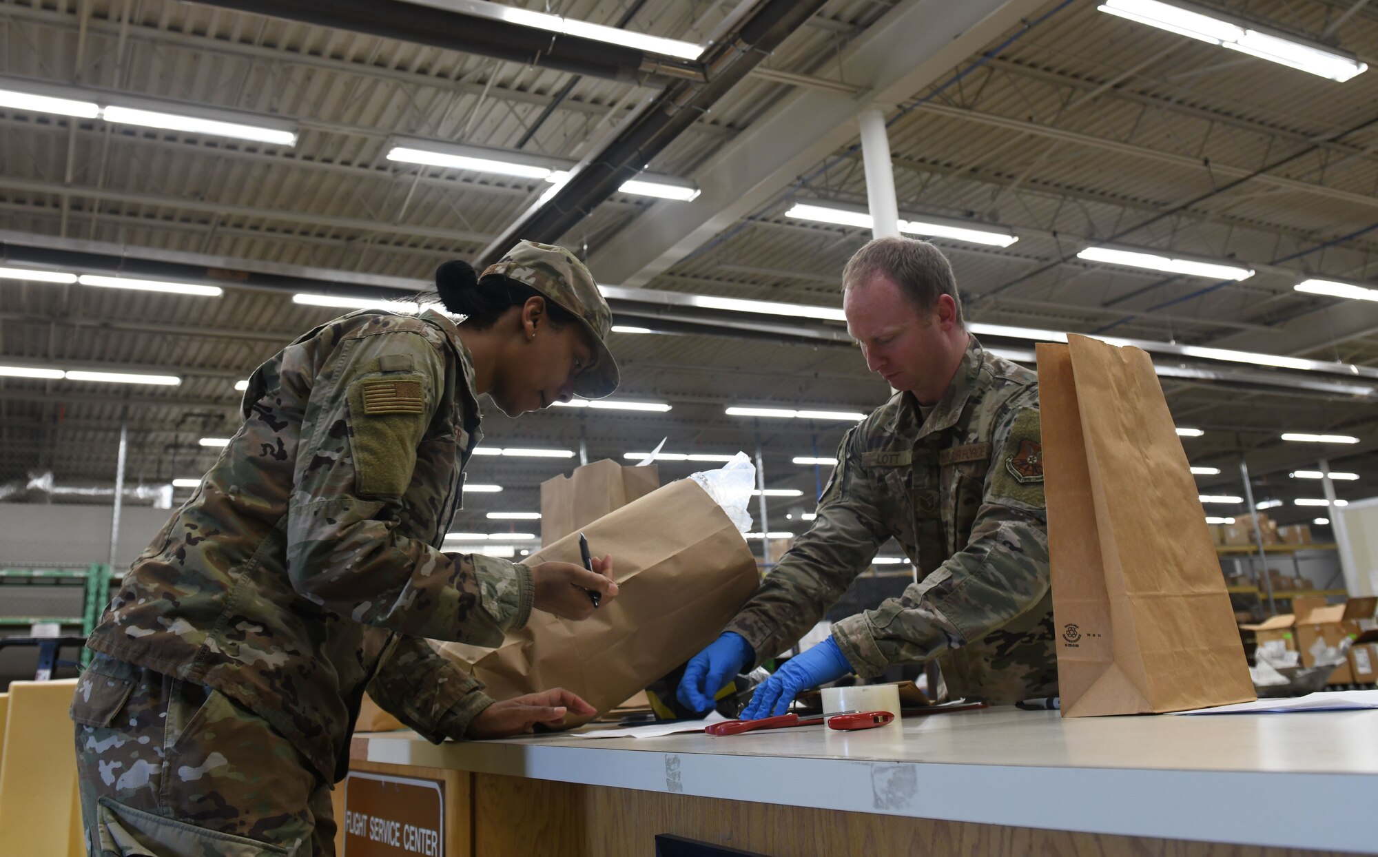Tech. Sgt. Justin Lott, a 28th Logistics Readiness Squadron asset management section chief, provides a customer with face masks at the Flight Service Center on Ellsworth Air Force Base, S.D., April 21, 2020. The 28th Contracting Squadron ordered 7,300 face masks for base dissemination, in an effort to battle the COVID-19 pandemic. (U.S. Air Force photo by Airman 1st Class Christina Bennett)