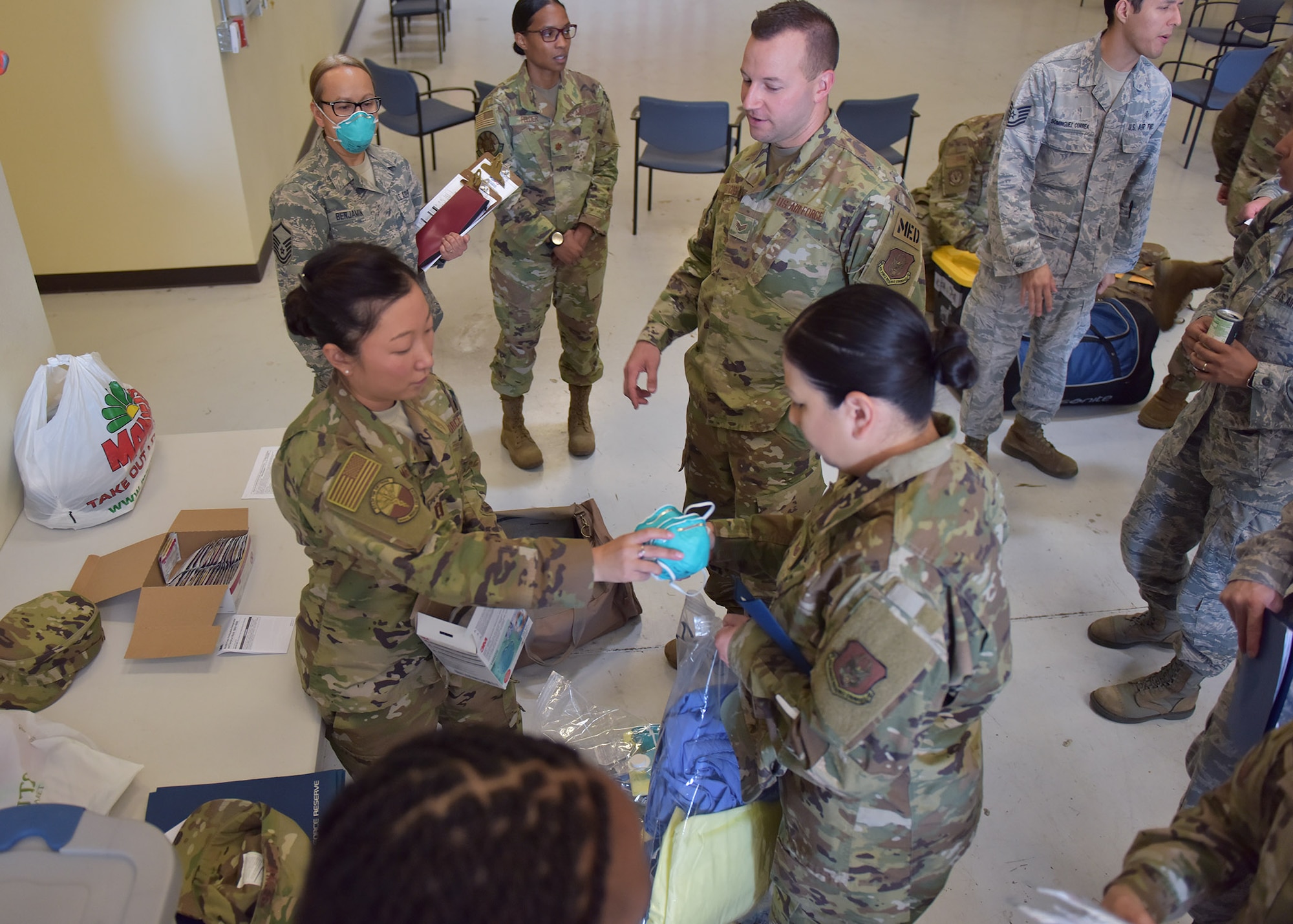 944th Medical and Aeromedical Staging Squadron Reserve Citizen Airmen receive Personal Protective Equipment April 22 as they prepare for deployment at Luke Air Force Base, Ariz. Over a dozen 944th Fighter Wing medics were tasked to aid in Coronavirus response in and around New York City. (U.S. Air Force photo by Tech. Sgt. Louis Vega Jr.)