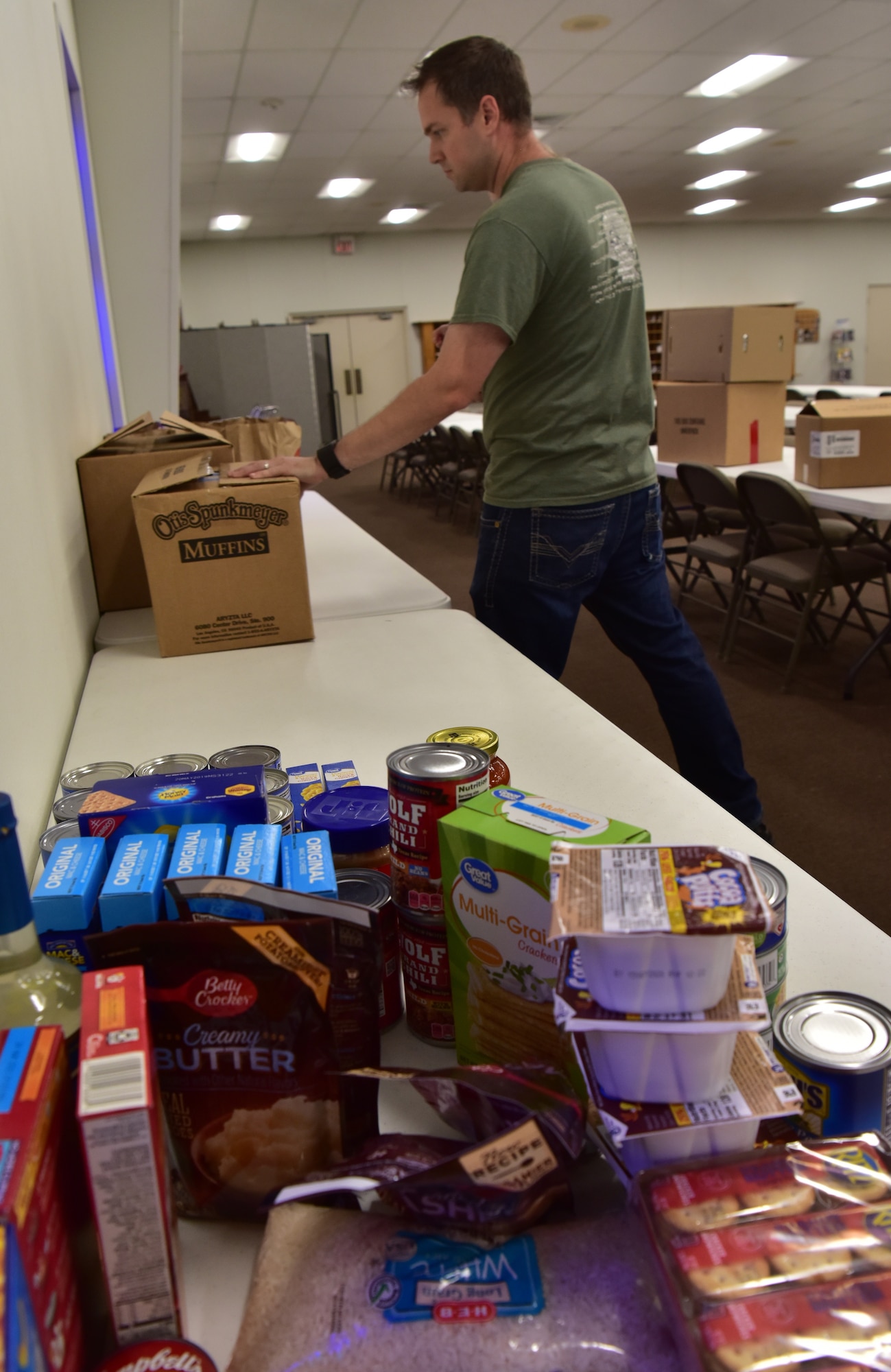 U.S. Air Force Capt. Jonathan Shour, 17th Training Wing chaplain, organizes donations during a food drive at Trinity Lutheran Church in San Angelo, Texas, April 22, 2020. The food drive is a joint effort between Goodfellow Air Force Base and the local community to help with shortages at local food banks. (U.S. Air Force photo by Staff Sgt. Chad Warren)