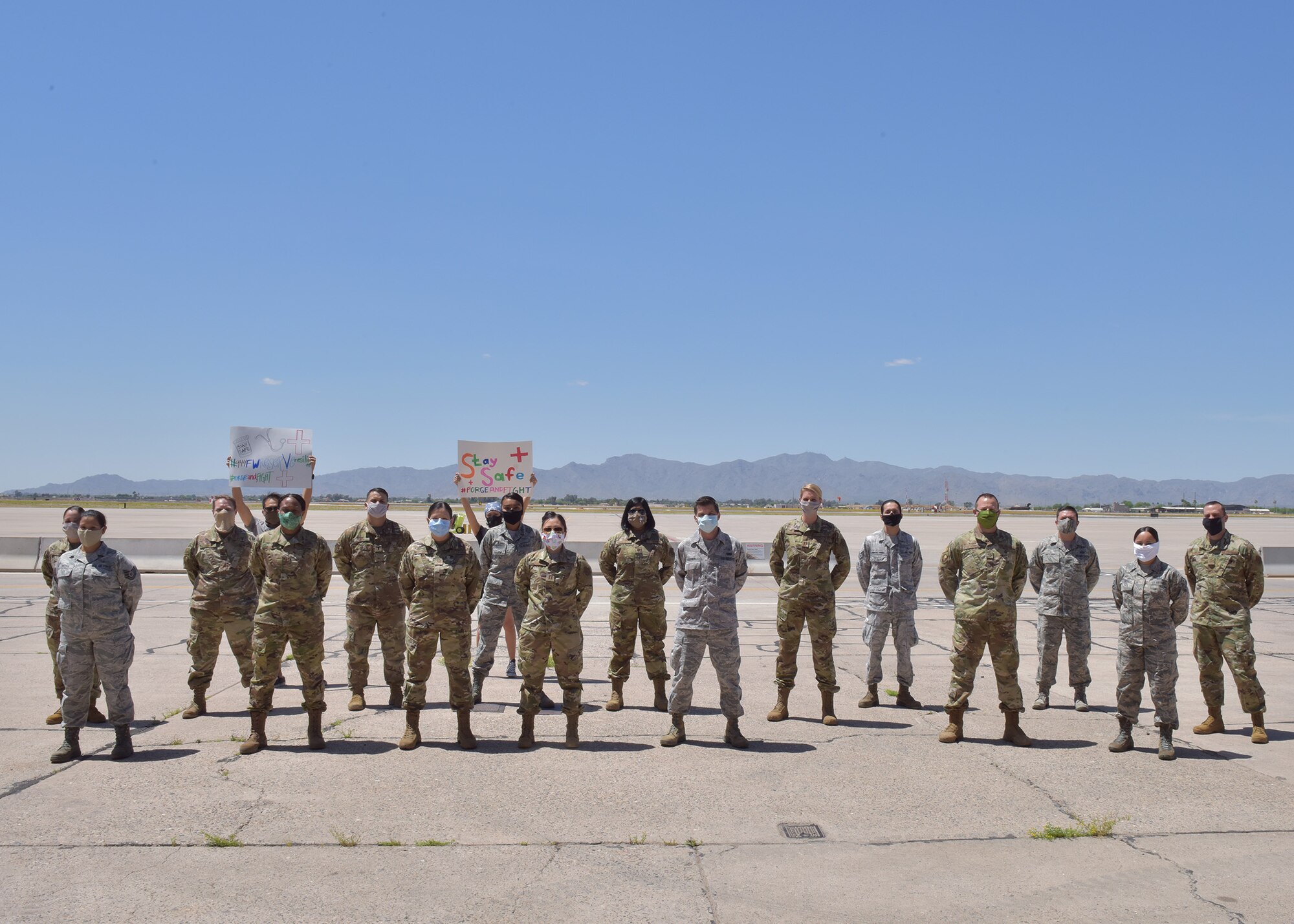 The team of medical professionals departing for COVID-19 response gather with wing support personnel while awaiting transportation to Joint Base McGuire-Dix-Lakehurst in New Jersey.  Over a dozen 944th Fighter Wing medics were tasked to aid in Coronavirus response in and around New York City. (U.S. Air Force photo by Tech. Sgt. Louis Vega Jr.)