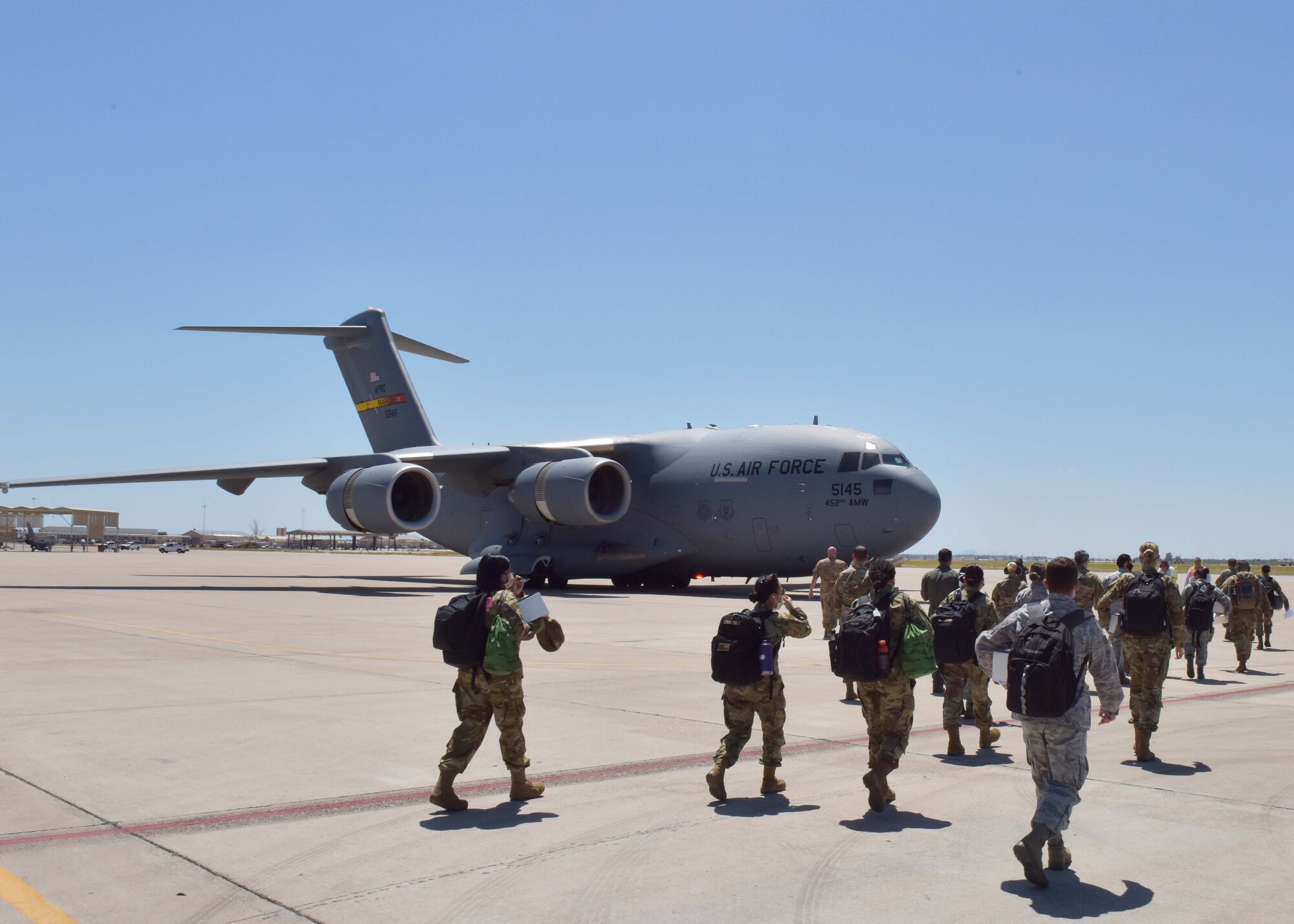 944th Medical and Aeromedical Staging Squadron Reserve Citizen Airmen board a C-17 April 22 at Luke Air Force Base, Ariz. Over a dozen 944th Fighter Wing medics were tasked to aid in Coronavirus response in and around New York City. (U.S. Air Force photo by Tech. Sgt. Louis Vega Jr.)