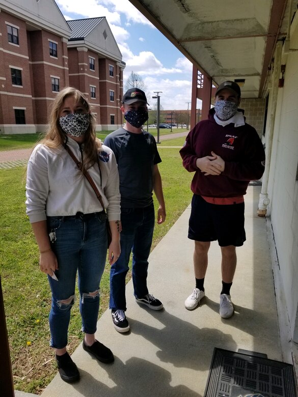 U.S. Air Force Airmen wearing homemade masks made by Langley Spouses Club members stand by dorms at Joint Base Langley-Eustis, Virginia, April 16, 2020. Along with social distancing and washing hands, wearing face masks help create another line of defense to protect from the coronavirus. (Courtesy photo)