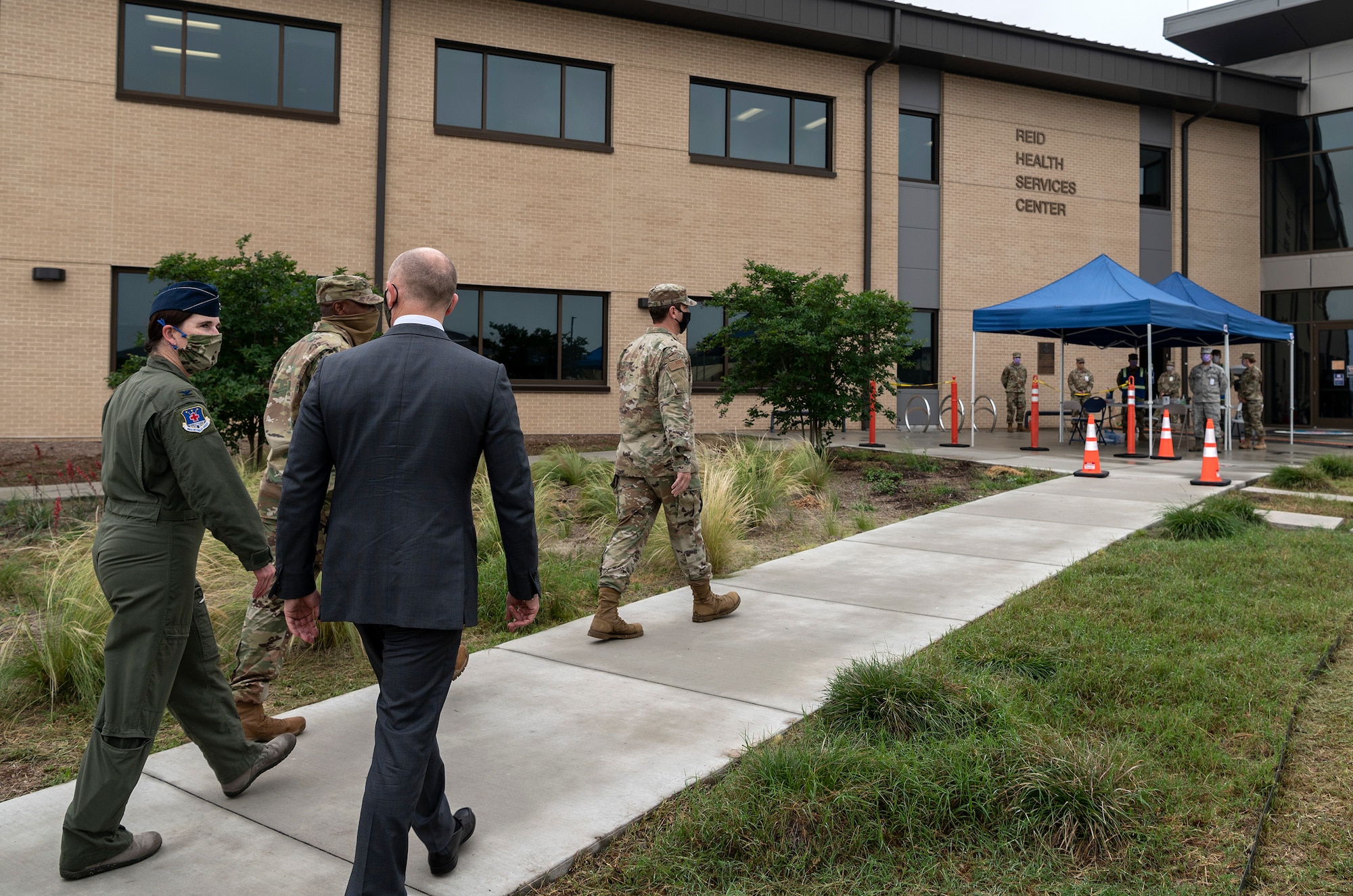 individuals walking a sidewalk