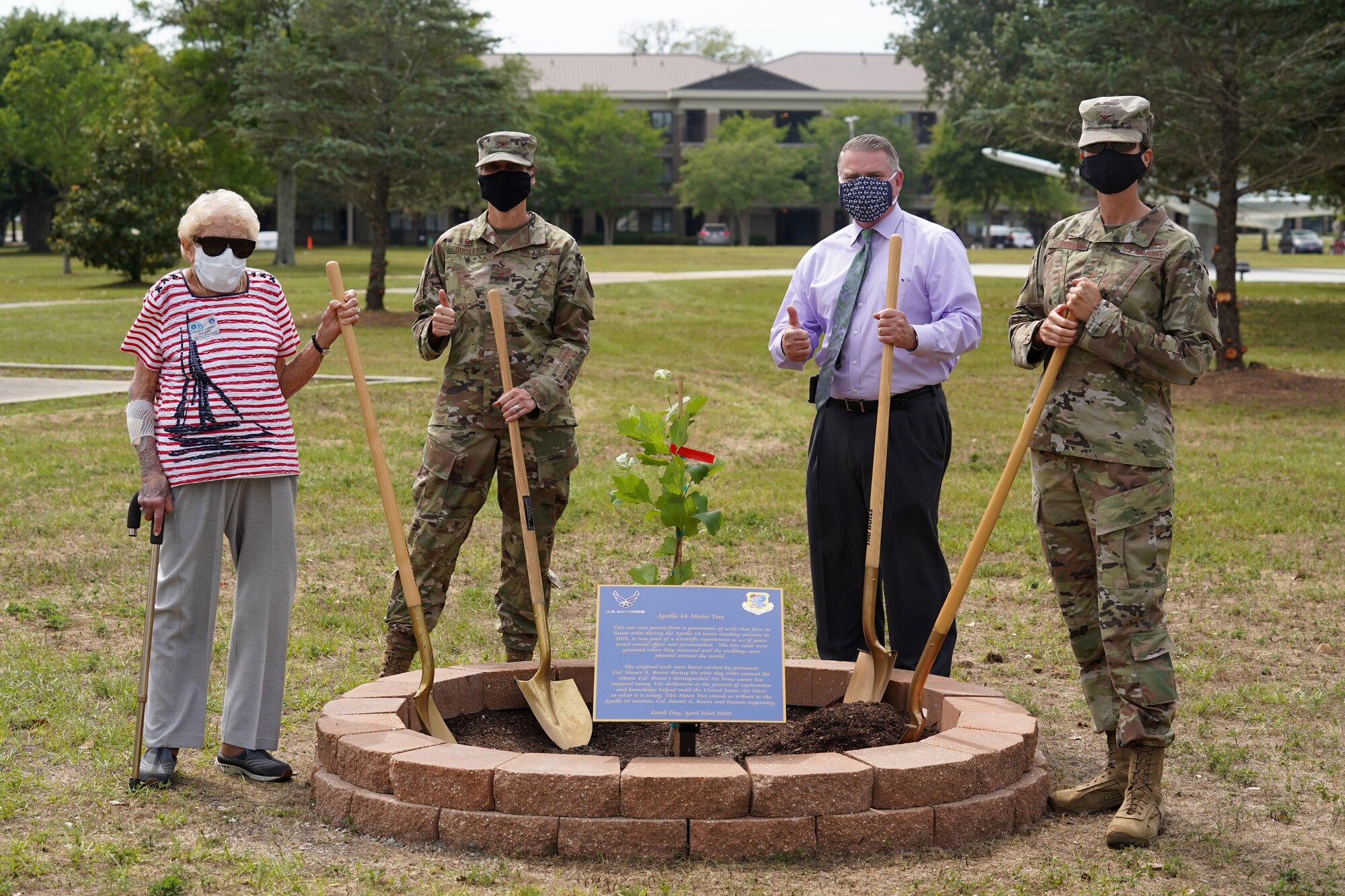 Keesler leadership and community members pose for a picture during a tree-planting ceremony at Keesler Air Force Base, Mississippi, April 22, 2020. The tree was grown from a generation of seeds that flew with astronaut Col. Stuart A. Roosa as an experiment on mission Apollo 14. The tree was planted on Earth Day as a tribute to Apollo 14, Roosa, and human ingenuity. (U.S. Air Force photo by Airman 1st Class Seth Haddix)