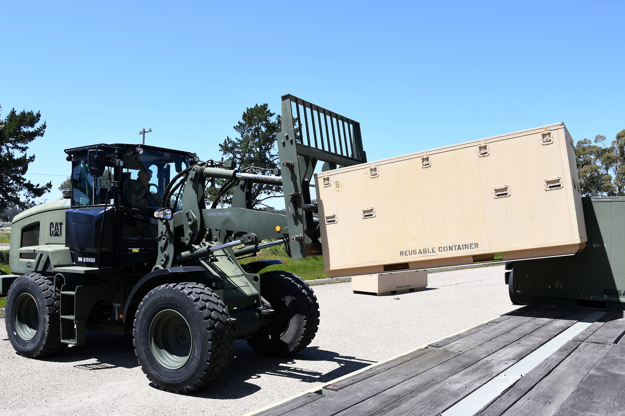 Airman 1st Class Chance Pickell, 30th Logistics Readiness Squadron ground transportation operator, loads a container of cots April 22, 2020, at Vandenberg Air Force Base, Calif.