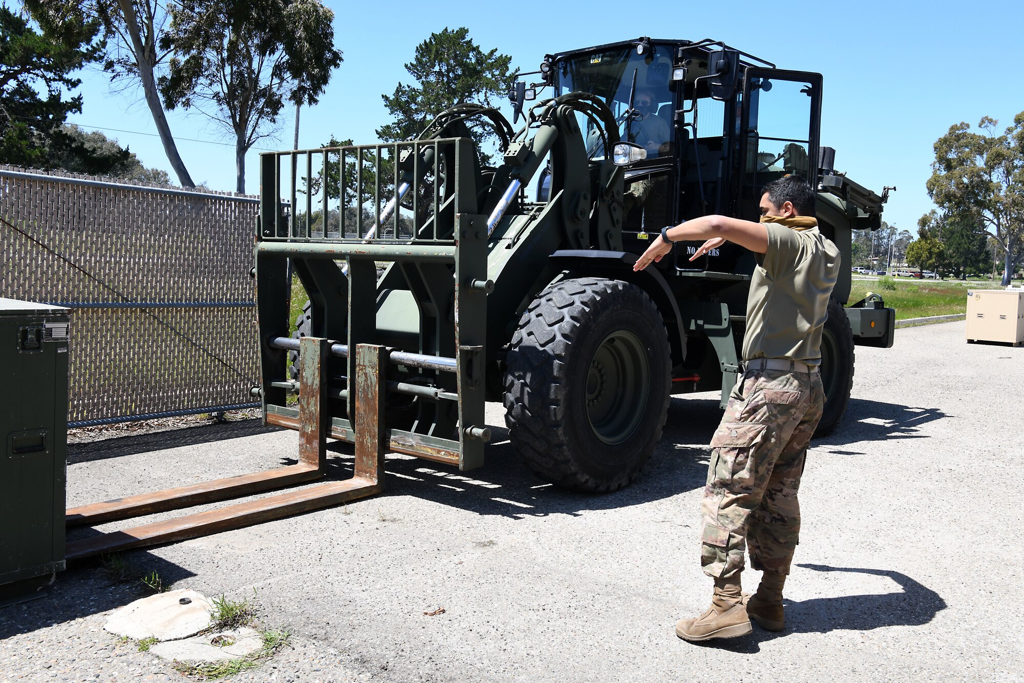 Senior Airman Nicholette Alonge and Airman 1st Class Chance Pickell, 30th Logistics Readiness Squadron ground transportation operators, move containers of cots April 22, 2020, at Vandenberg Air Force Base, Calif.