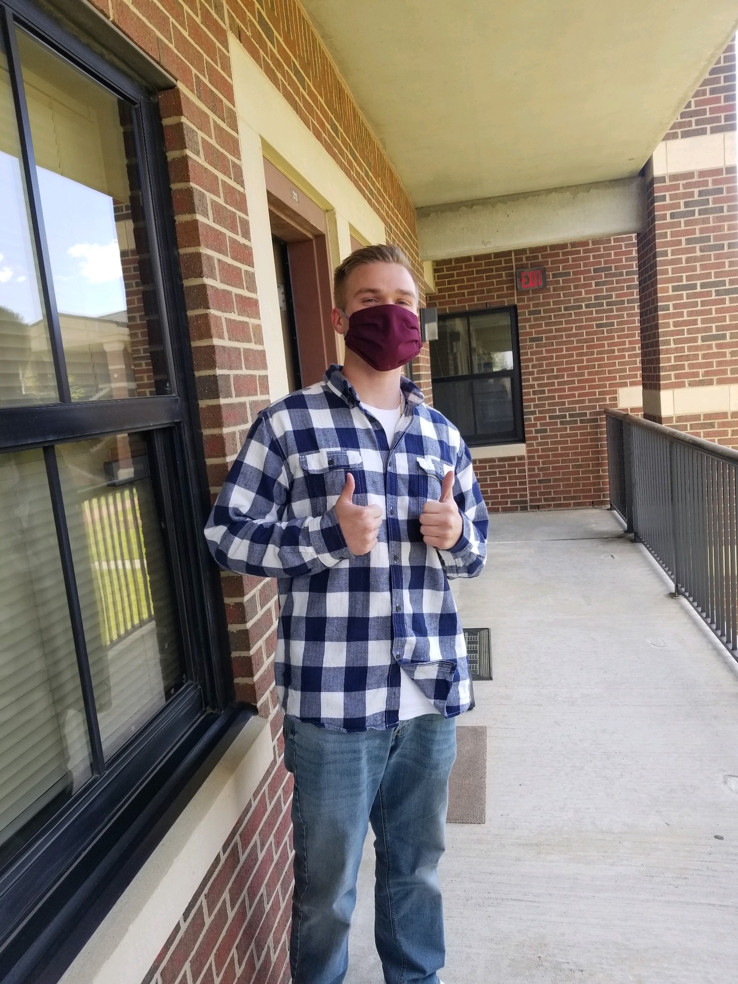A U.S. Air Force Airman poses for a photo in his new mask at Joint Base Langley-Eustis, Virginia, April 16, 2020. Masks made by the Langley Spouses Club helped keep Airmen safe from COVID-19 while also adhering to dress and appearance standards. (Courtesy photo)