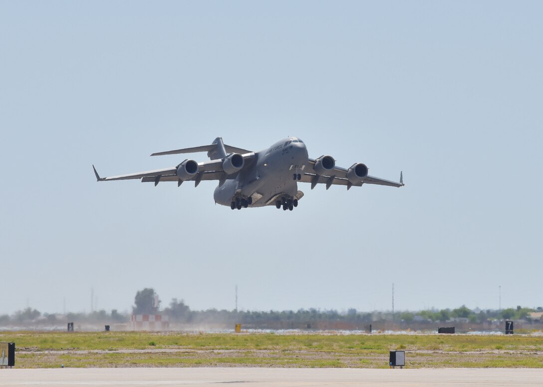 A C-17 originating from March Air Force Base, Calif. departs Luke Air Force Base, Ariz. April 22. The aircraft made a quick stop to pick up over a dozen 944th Fighter Wing medics who were tasked to aid in Coronavirus response in and around New York City. (U.S. Air Force photo by Tech. Sgt. Louis Vega Jr.)