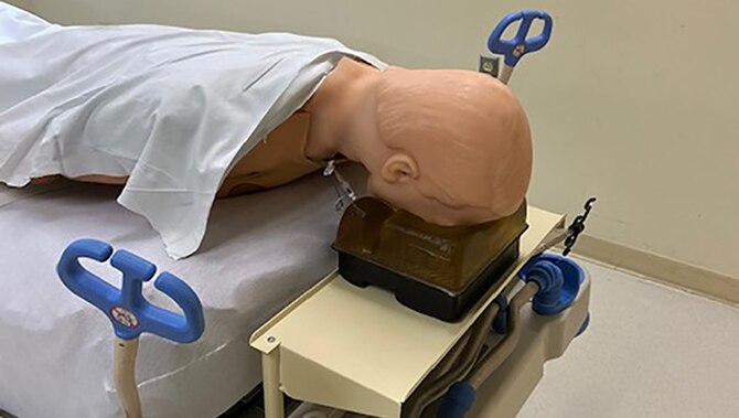 A simulation model at Keesler Air Force Base lies on a newly designed pronating shelf, designed to assisted COVID-19 patients with their breathing. (Courtesy photo)