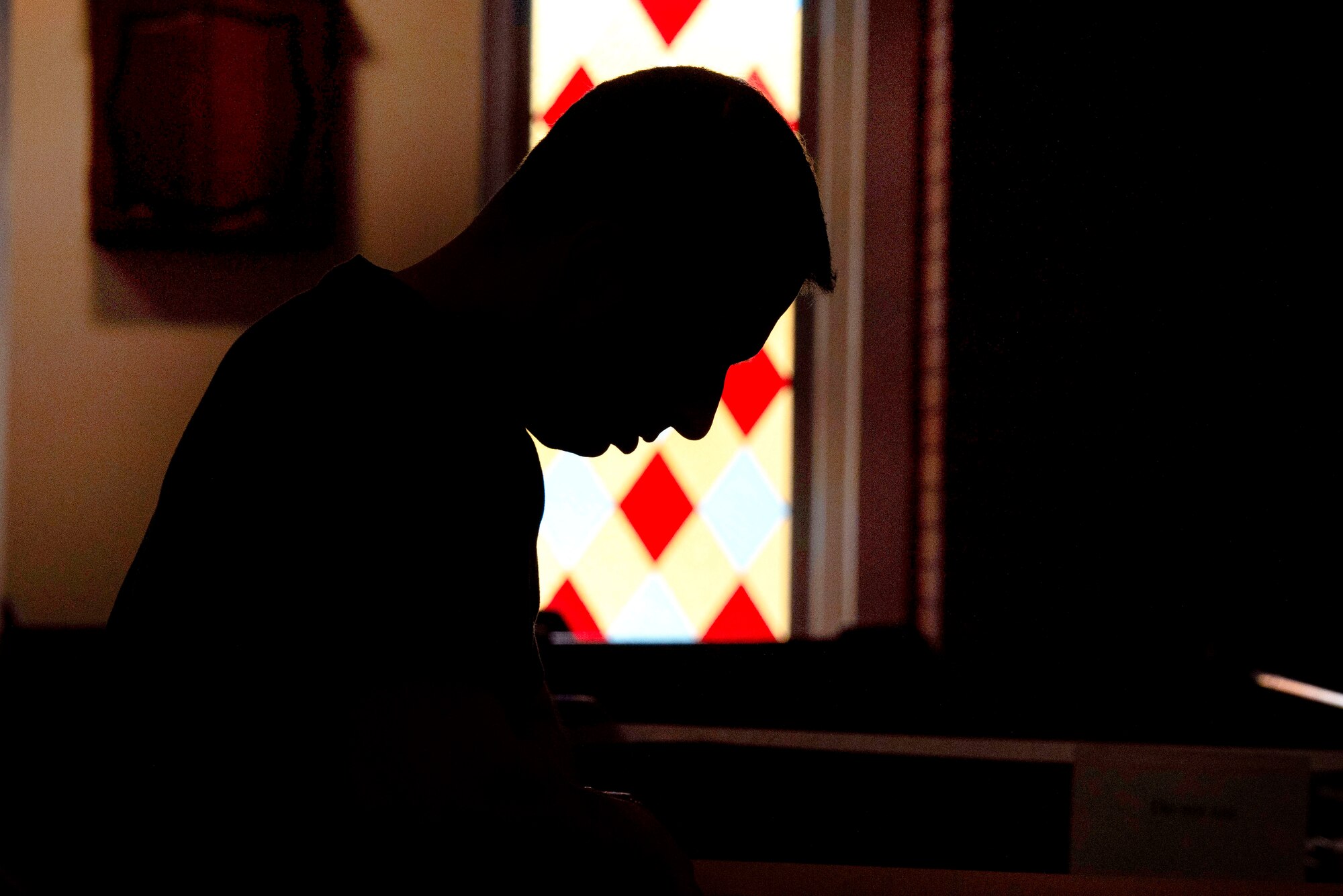 U.S. Air Force Lt. Col. Robert Orlando, 39th Medical Support Squadron commander, prays during a recorded worship service April 18, 2020, at Incirlik Air Base, Turkey. The 39th Air Base Wing chapel modified its operations to continue supporting the spiritual needs of Airmen while maintaining COVID-19 precautions according to Centers for Disease Control guidelines. (U.S. Air Force photo by Staff Sgt. Joshua Magbanua)