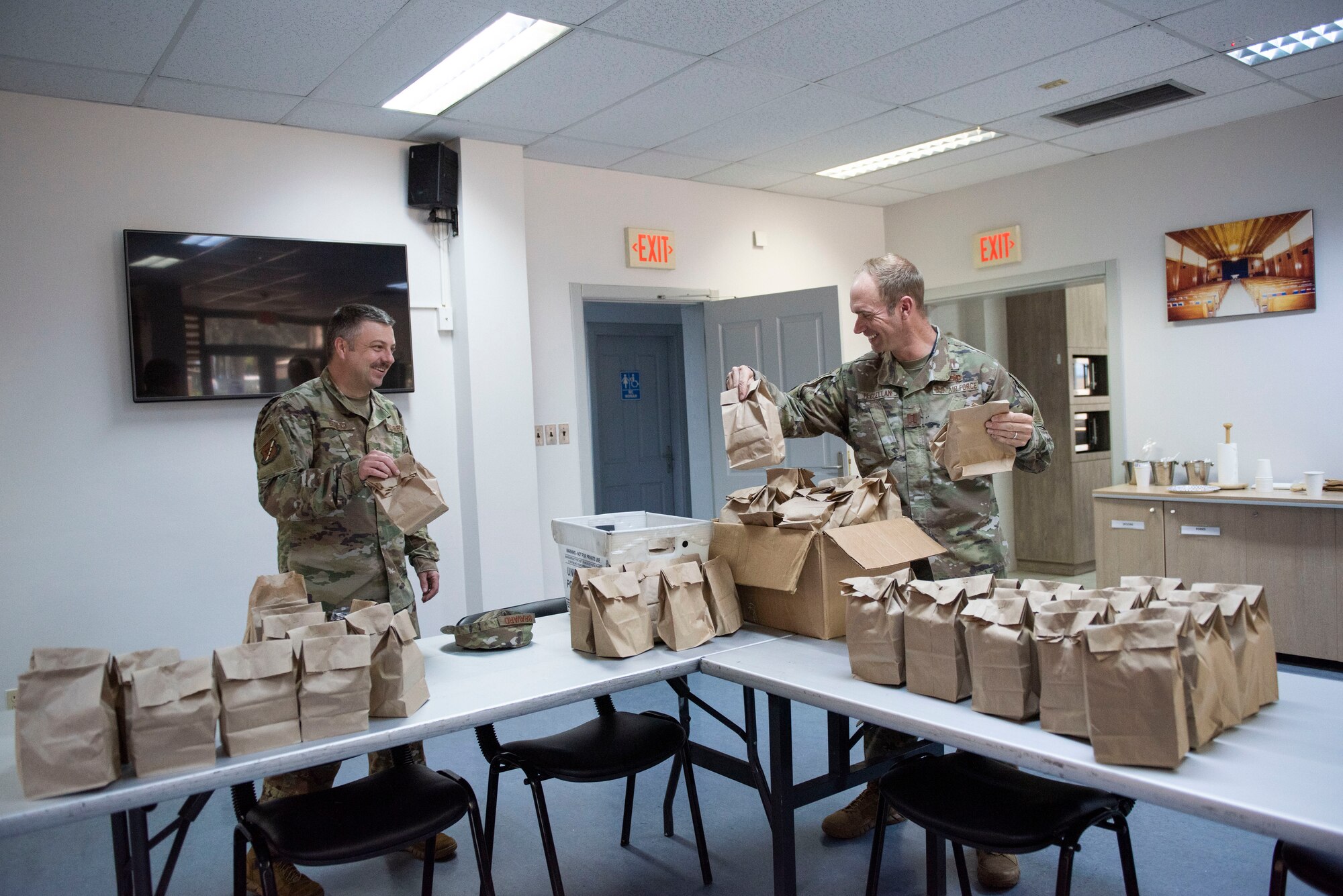 U.S. Air Force Staff Sgt. Jason Bravard, 39th Air Base Wing chapel non-commissioned officer in charge of resource management, (left), and U.S. Air Force Capt. Samuel McClellan, a chaplain, prepare care packages April 14, 2020, at Incirlik Air Base, Turkey. The 39th ABW chapel assembled care packages with their contact information attached in order to help community members reach out to them during the COVID-19 pandemic. (U.S. Air Force photo by Staff Sgt. Joshua Magbanua)