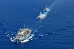 200422-N-NO090-0003 MEDITERRANEAN SEA- The Arleigh Burke-class guided-missile destroyer USS Porter (DDG 78), USNS Supply (T-AOE 6), and ITS Federico Martinengo (F 596) conduct a photo exercise (PHOTOEX) while conducting joint operations to ensure maritime security in the Mediterranean Sea, 22 April. The frequent seamless operations between the Italian and American navies demonstrate strength and professionalism inherent in steady, practiced partnership. U.S. 6th Fleet, headquartered in Naples, Italy, conducts the full spectrum of joint and naval operations, often in concert with allied and interagency partners, in order to advance U.S. national interests and security and stability in Europe and Africa. (Photo courtesy of U.S. Navy)