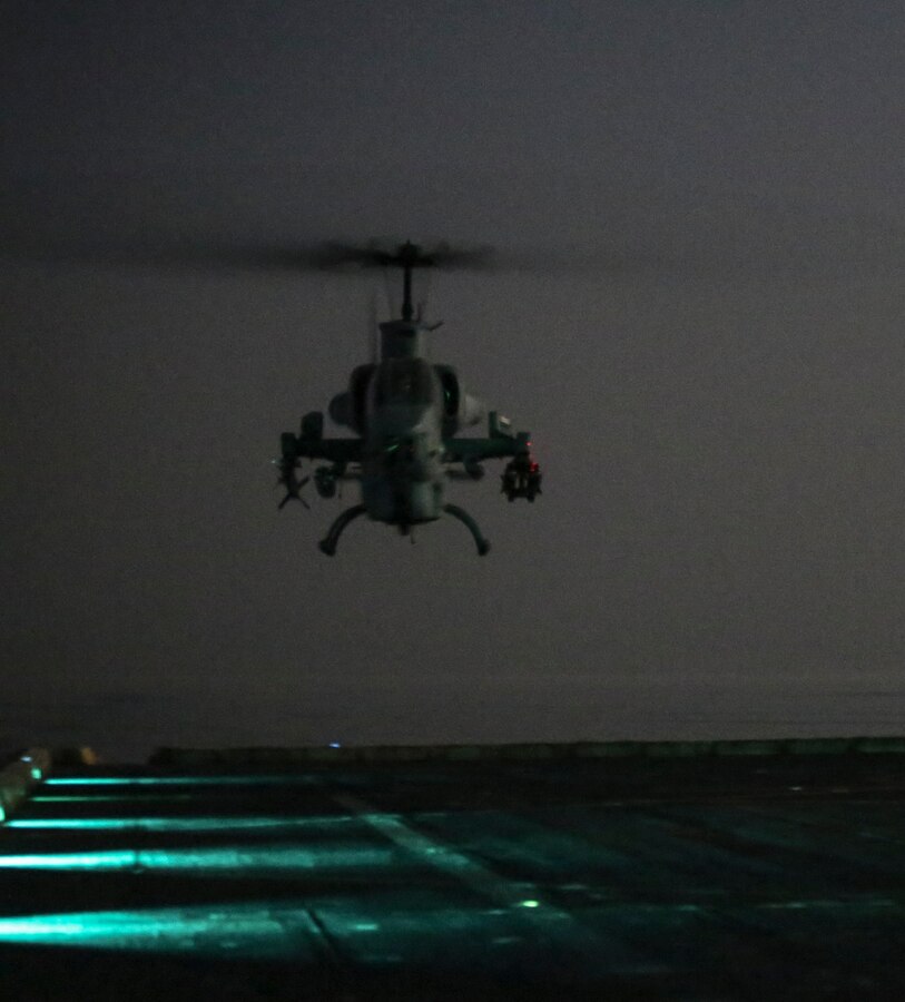 200407-M-MV109-1129 U.S. 5TH FLEET AREA OF OPERATIONS (April 7, 2020) A U.S. Marine Corps AH-1W Super Cobra assigned to Marine Medium Tiltrotor Squadron (VMM) 365 (reinforced), 26th Marine Expeditionary Unit (MEU), prepares to land on the flight deck of the amphibious transport dock USS New York (LPD 21) April 7, 2020. New York, with embarked 26th MEU, is deployed to the U.S. 5th Fleet area of operations in support of naval operations to ensure maritime stability and security in the Central Region, connecting the Mediterranean and Pacific through the Western Indian Ocean and three strategic choke points. (Marine Corps photo by Staff Sgt. Patricia A. Morris)