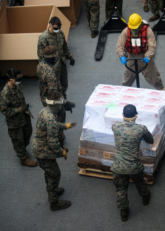 200408-M-MV109-1271 U.S. 5TH FLEET AREA OF OPERATIONS (April 8, 2020) Marines assigned to the 26th Marine Expeditionary Unit stage pallets during a replenishment-at-sea aboard the amphibious transport dock USS New York (LPD 21) April 8, 2020. New York, with embarked 26th MEU, is deployed to the U.S. 5th Fleet area of operations in support of naval operations to ensure maritime stability and security in the Central Region, connecting the Mediterranean and Pacific through the Western Indian Ocean and three strategic choke points. (Marine Corps photo by Staff Sgt. Patricia A. Morris)