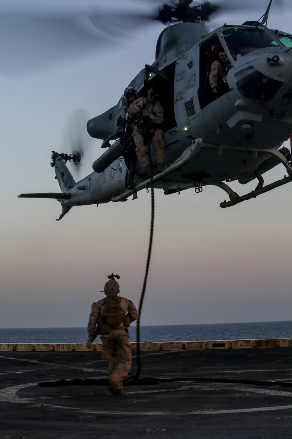 200414-M-MV109-2171 U.S. 5TH FLEET AREA OF OPERATIONS (April 14, 2020) Marines assigned to the Maritime Raid Force, 26th Marine Expeditionary Unit (MEU), fast-rope from a UH-1Y Venom aboard the amphibious transport dock USS New York (LPD 21) April 14, 2020. New York, with embarked 26th MEU, is deployed to the U.S. 5th Fleet area of operations in support of naval operations to ensure maritime stability and security in the Central Region, connecting the Mediterranean and Pacific through the Western Indian Ocean and three strategic choke points. (Marine Corps photo by Staff Sgt. Patricia A. Morris)
