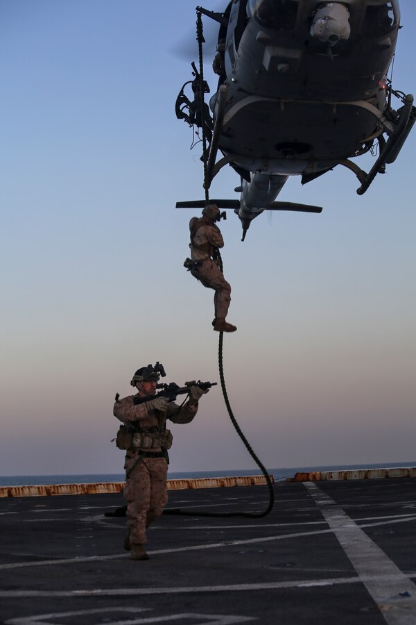 200414-M-MV109-2199 U.S. 5TH FLEET AREA OF OPERATIONS (April 14, 2020) Marines assigned to the Maritime Raid Force, 26th Marine Expeditionary Unit (MEU), fast-rope from a UH-1Y Venom aboard the amphibious transport dock USS New York (LPD 21) April 14, 2020. New York, with embarked 26th MEU, is deployed to the U.S. 5th Fleet area of operations in support of naval operations to ensure maritime stability and security in the Central Region, connecting the Mediterranean and Pacific through the Western Indian Ocean and three strategic choke points. (Marine Corps photo by Staff Sgt. Patricia A. Morris)