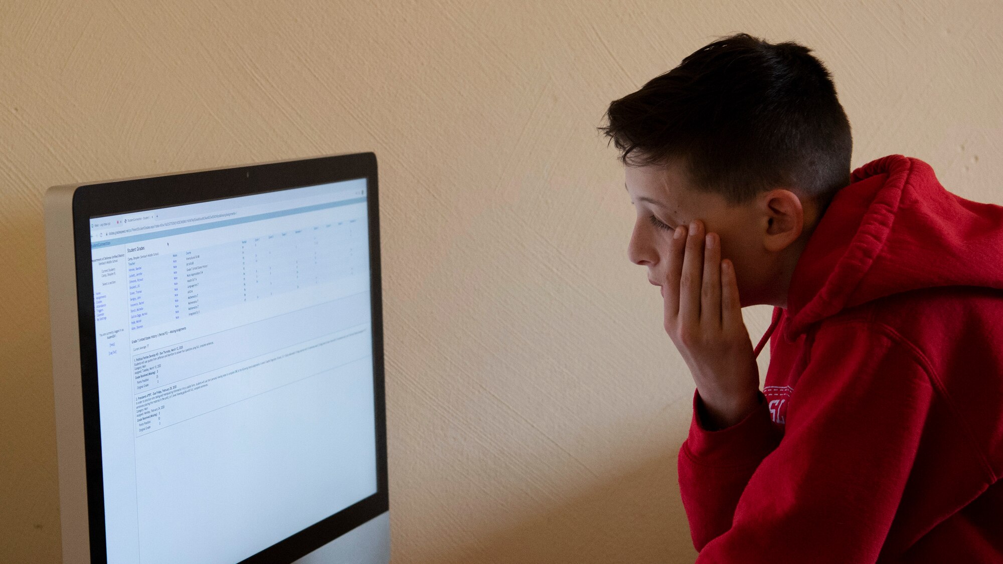 Braylen, son of U.S. Army Sgt. 1st Class Cody Camp, U.S. Army Recruiting Command senior guidance counselor, reads through classwork from his home in Kaiserslautern