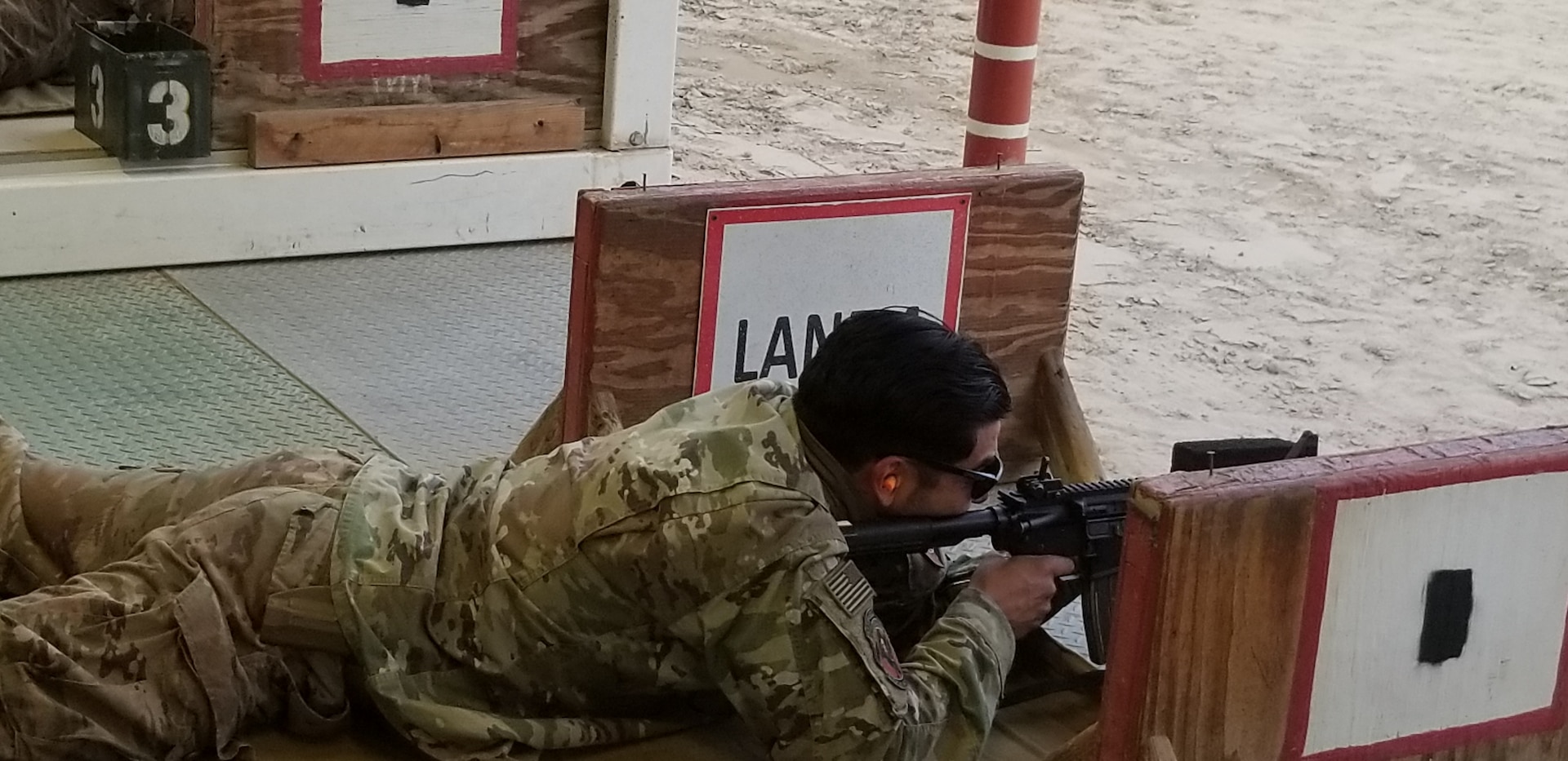 Navy Petty Officer Second Class Alejandro Garcia joins his fellow reservists practice social distancing along with their small arms skills during familiarization and practice training during their deployment supporting DLA Disposition Services operations in Afghanistan.
