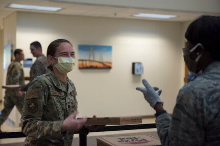 Major Michelle Law-Gordon, 628th Air Base Wing senior installation chaplain, and Lt. Col. Christine Smetana, the 628th Operational Medical Readiness Squadron Commander, talk about the morale event happening at the 628th Medical Group at Joint Base Charleston, S.C. April 22, 2020. JB Charleston chaplains passed out pizza and sandwiches to raise morale and thank Medical Group personnel for all their hard work during the COVID-19 pandemic. The chaplains wore masks and gloves to protect the Airmen they handed food to.