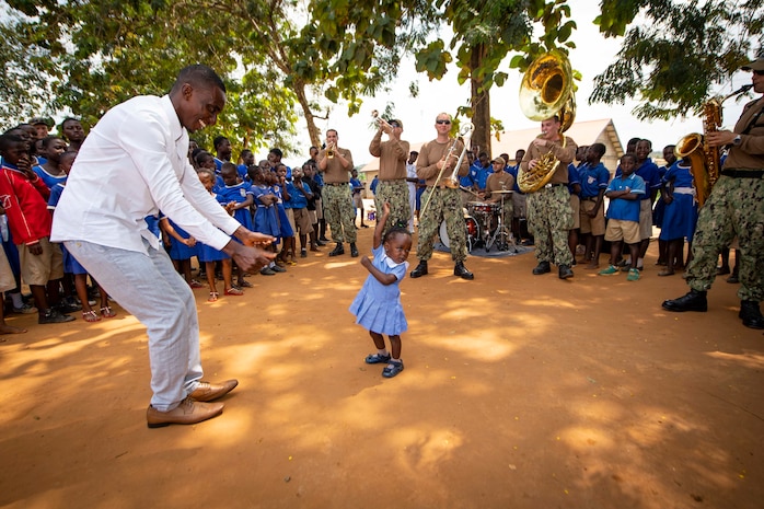 Students at St. John's Anglican Primary School dance as the U.S. Naval Forces Europe Band "Topside," embarked aboard the Spearhead-class expeditionary fast transport ship USNS Carson City (T-EPF 7), performs during a community relations project in Takoradi, Ghana, July 23, 2019.