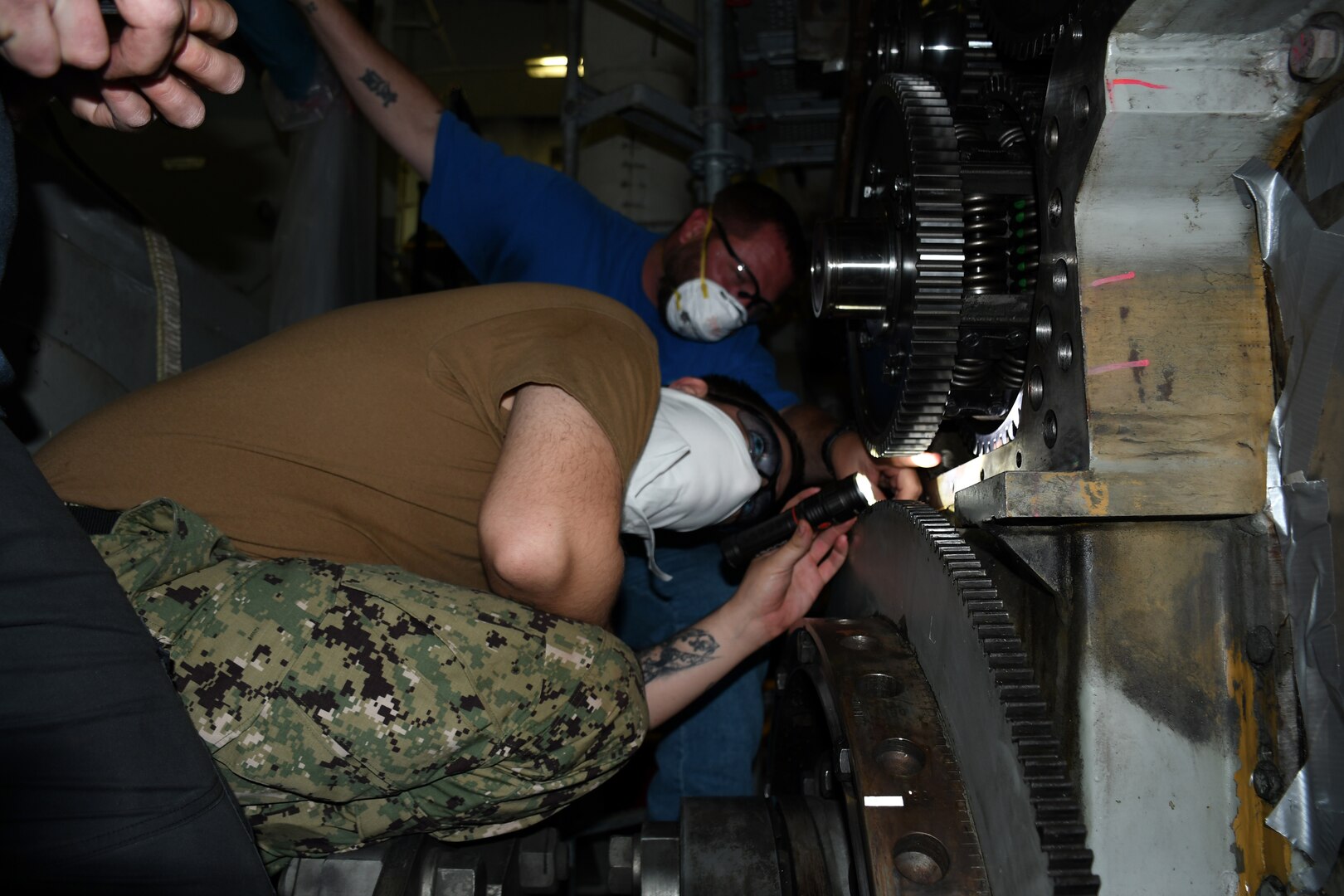 NNSY’s Shop 38 Engineman Second Class Brian Rosenbeck and Diesel Shop Code 930 Work Leader Tony Schwartz are taking readings on an idler assembly to ensure there is proper clearance between the gear teeth onboard USS John C. Stennis (CVN 74).