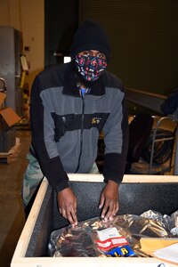 NNSY’s Shop 67HS Marine Machinist Davell Lloyd performs a receipt inspections on an antenna cable.