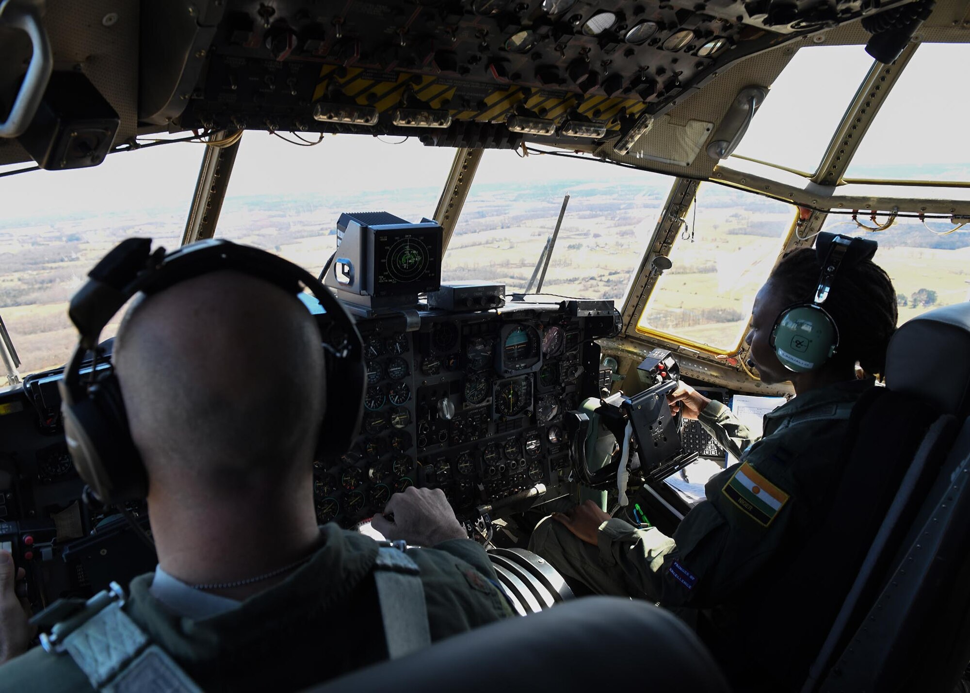 Two pilots fly a plane.
