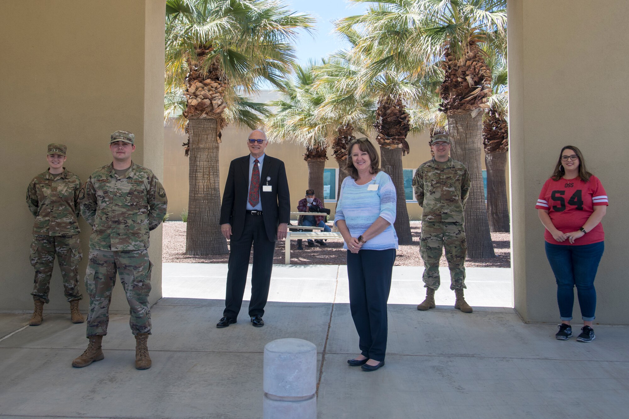 The team of 3-D printing enthusiasts, Tech. Sgt. Kyle Good, 54th Operations Support Squadron and White Sands Missile Range Air Traffic Control watch supervisor, and his wife, Jamie Good; Staff Sgt. Jakob Powers and his wife, Staff Sgt. Kaitlyn Powers; both 54th OSS air traffic controllers, and Gerald Champion Regional Medical Center staff members pose for a photo at Gerald Champion Regional Medical Center in Alamogordo, N.M. on April 16, 2020. After delivering the face-covering extenders to staff members of the hospital, the group gathered for a photo, while maintaining six feet of distance, to document this historical moment. (U.S. Air Force photo by Senior Airman Collette Brooks)