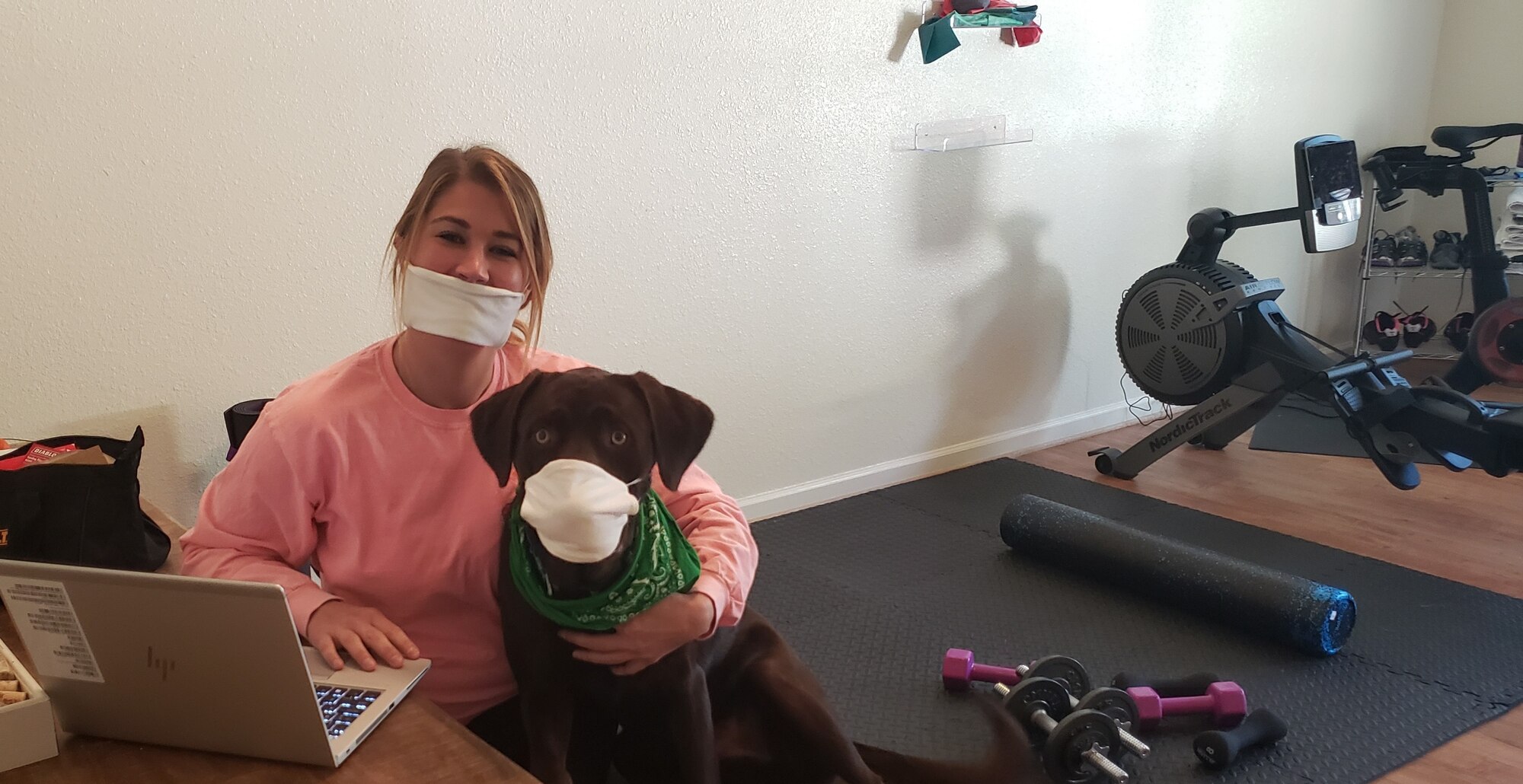 woman and dog sitting together at home workstation