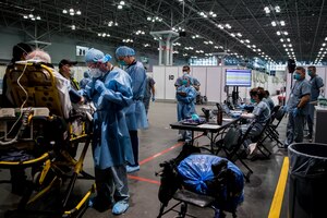 Army Spc. Daniel Fields, assigned to the 9th Hospital Center, takes a patient’s blood pressure reading in the Javits New York Medical Station (JNYMS).