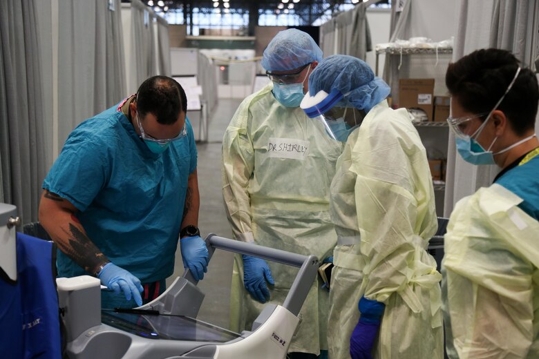 Service members assigned to the Javits New York Medical Station perform an X-ray scan on a COVID-19 patient in the facility’s intensive care unit, April 18, 2020.