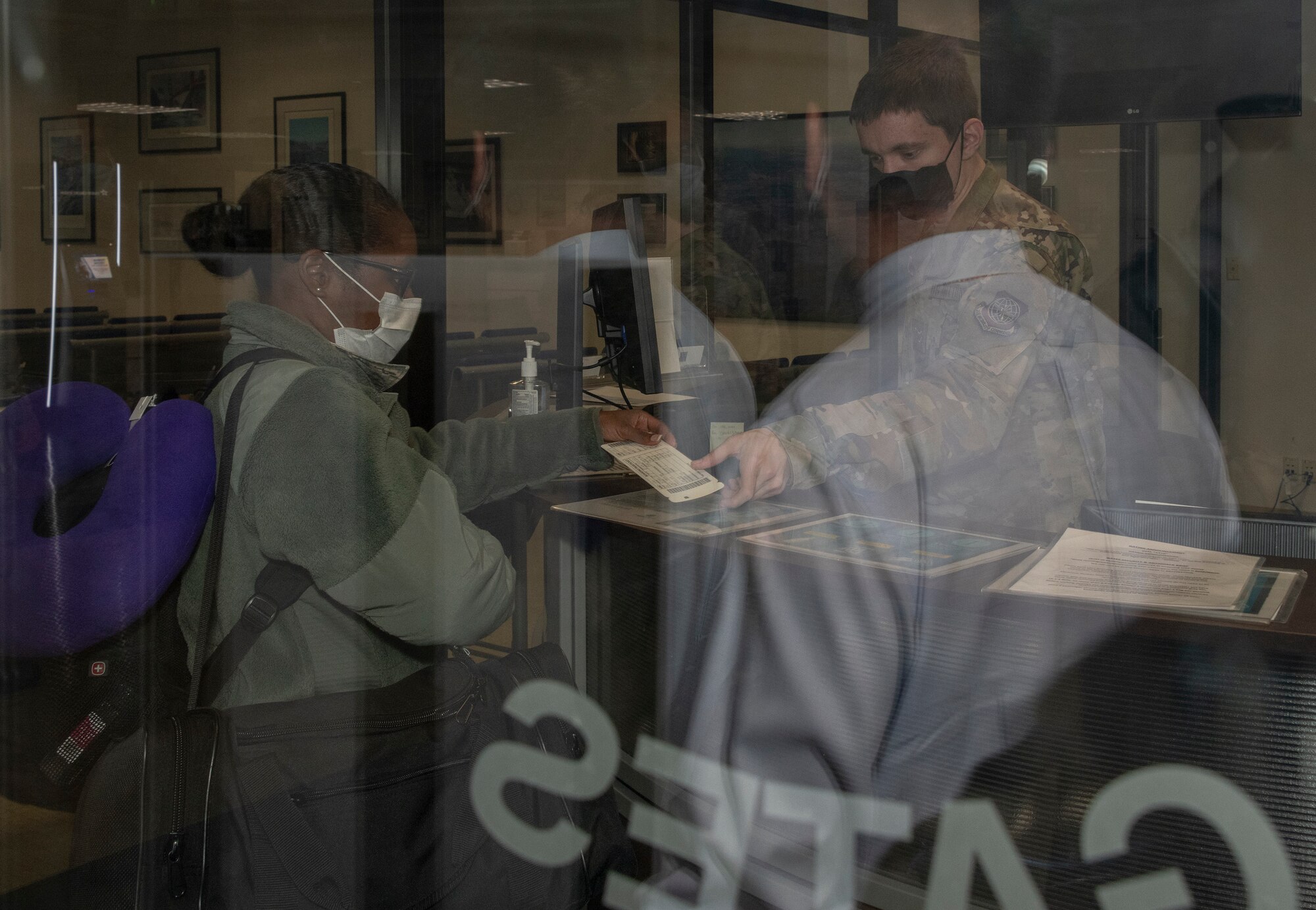 U.S. Air Force personnel from the 349th Medical Group pass through security at the passenger terminal April 22, 2020, at Travis Air Force Base, California. Medical staff from the 349th MDG deployed to New York in support of a short-notice COVID-19 mission. (U.S. Air Force photo by Heide Couch)