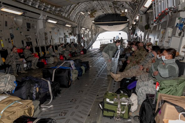 U.S. Air Force personnel from the 349th Medical Group prepare for takeoff inside a U.S. Air Force C-17 Globemaster III from March Air Reserve Base, California, April 22, 2020, at Travis Air Force Base, California. The aircraft provided deployment airlift for 349th MDG personnel from Travis AFB to New York in support of a short-notice COVID-19 mission. (U.S. Air Force photo by Heide Couch)