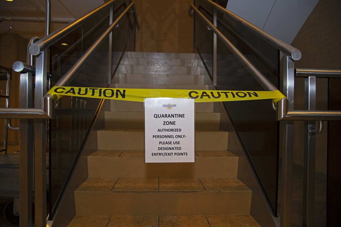 A quarantine sign and caution tape block the stairs in the Temporary Lodging Facility lobby at Joint Base Andrews, Md., April 13, 2020. The devoted TLF floor is dedicated to quarantine individuals traveling from out of state to ensure they present no symptoms.