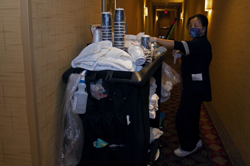 Ma Luisa Jones, Presidential Inn Housekeeping supervisor, uses supplies from her cart to clean and disinfect the rooms at the Temporary Lodging Facility on Joint Base Andrews, Md., April 13, 2020. The rooms and common areas are sanitized multiple times a day in efforts to keep the staff and guests safe from the coronavirus disease.