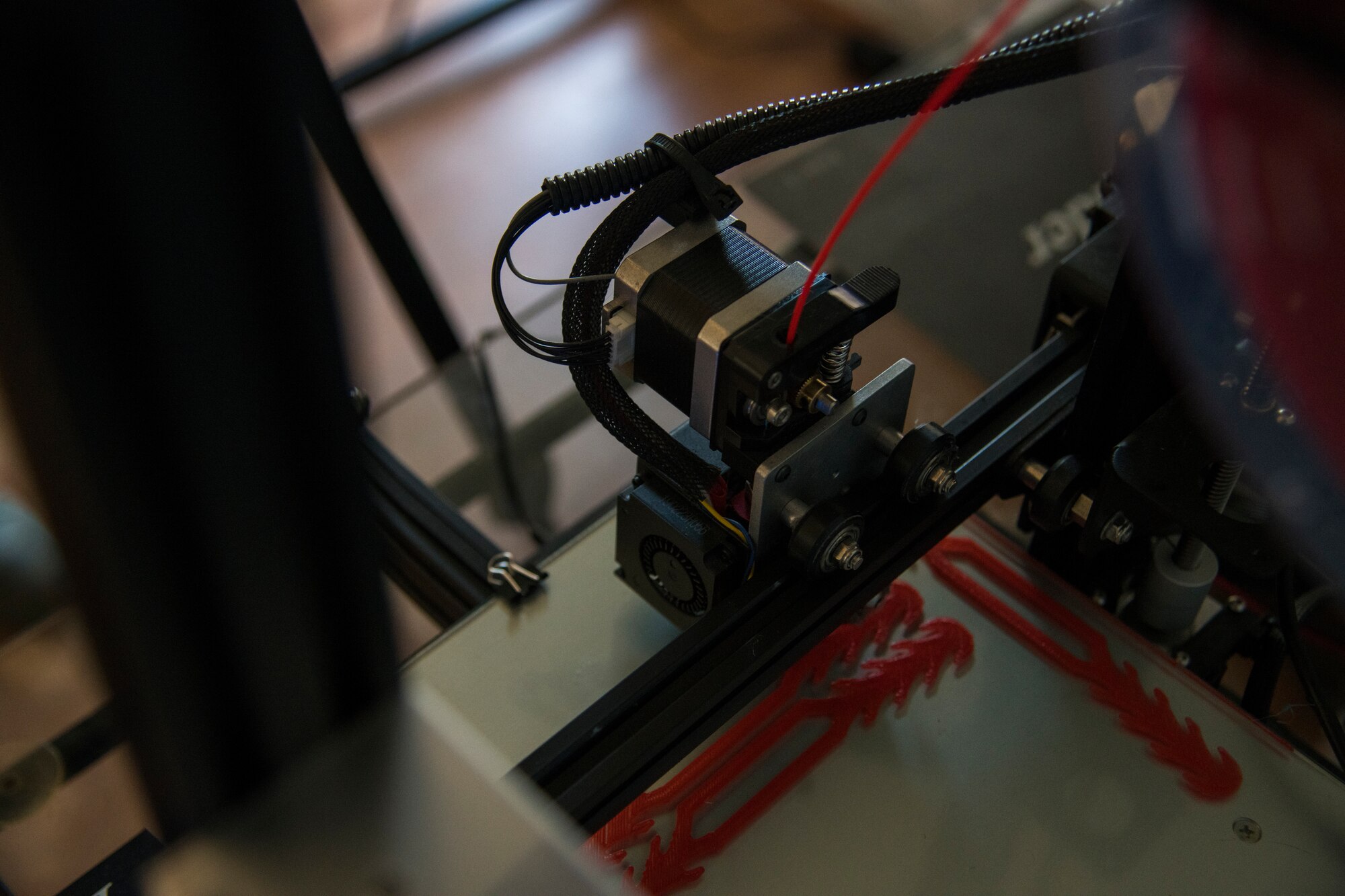 A 3-D printer prints face-covering extenders in Alamogordo, N.M., on April 16, 2020. Two Holloman Airmen and their spouses print face-shield frames and face-covering extenders from polylactic acid, a biodegradable thermoplastic, to support essential personnel such as medical workers, firefighters and police officers. (U.S. Air Force photo by Senior Airman Collette Brooks)