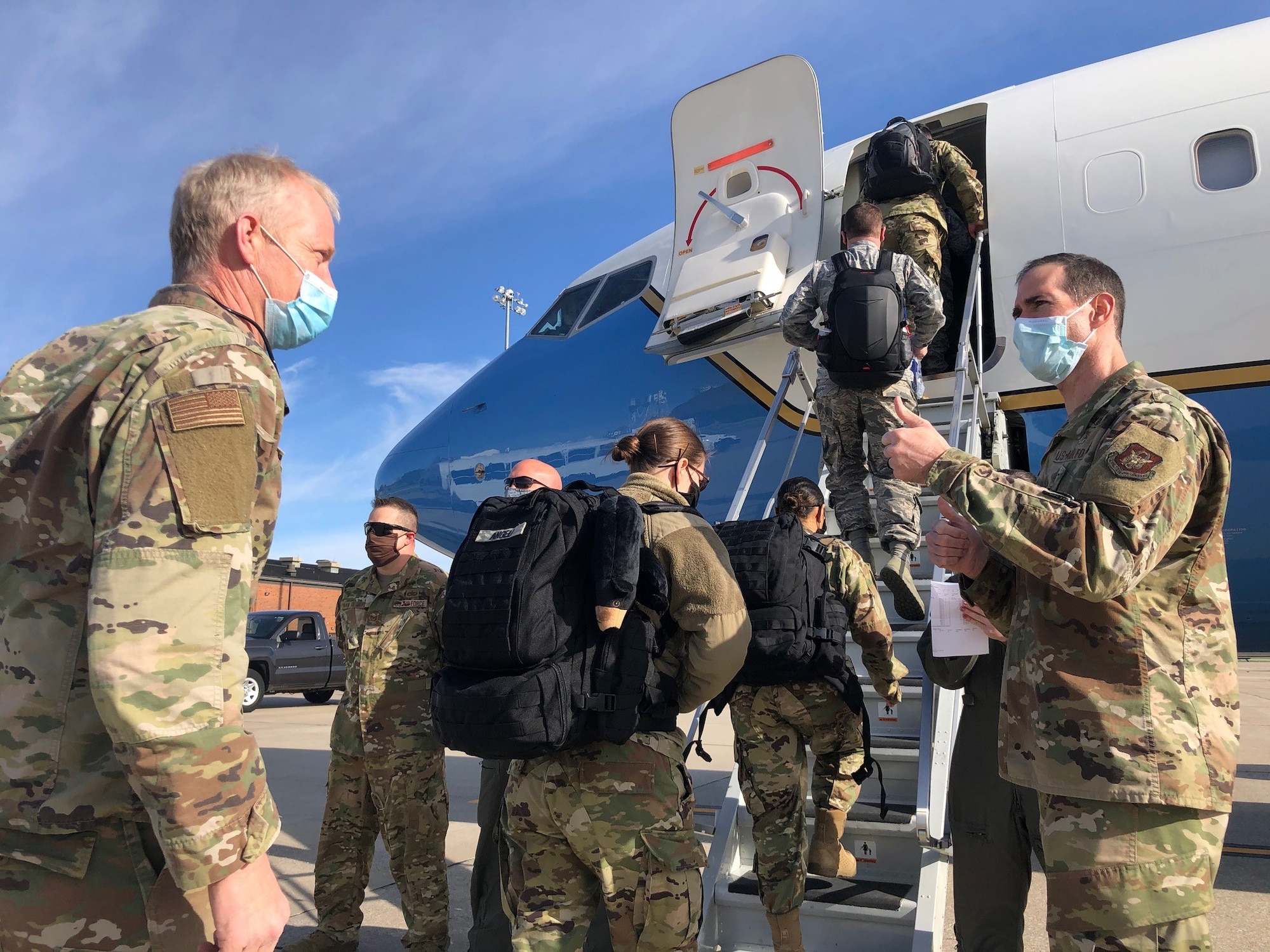 Master Sgt. Blair Bookland (left) and members of the 932nd Medical Group board an 932nd Airlift Wing C-40C, April 22 at Scott Air Force Base, Illinois to support COVID-19 relief efforts in New York. 932nd MDG commander, Col. Chris Spinelli (right) says farewell as they depart. This latest deployment brings the total of Air Force Reservists mobilized in support of COVID-19 relief efforts to more than 770 around the nation. (U.S. Air Force photo by Lt. Col. Stan Paregien)