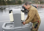 Pennsylvania National Guard 2nd Lt. Brianna Stetts, medical operations officer for the Headquarters and Headquarters Company, 1st Battalion, 109th Infantry Regiment, washes her hands after completing decontamination procedures at the COVID-19 testing site at Mohegan Sun Arena in Wilkes-Barre April 21, 2020.