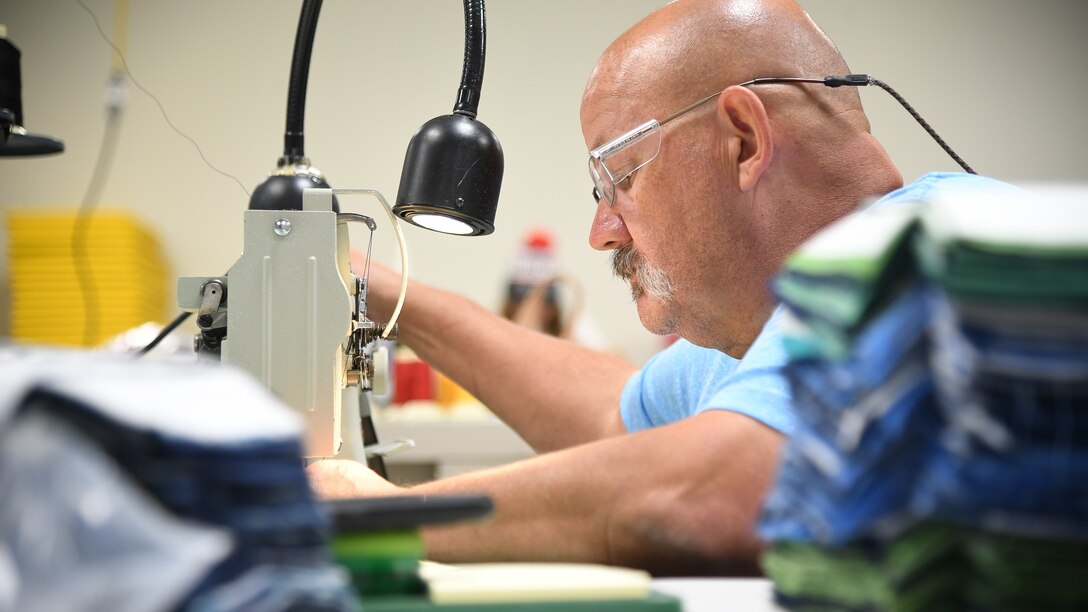 Aircrew Flight Equipment technicians with the 531st Armament Textile Shop make protective cloth masks at Hill Air Force Base, Utah, April 15, 2020. The shop is using their skill set and equipment to produce cloth face coverings for members of Team Hill. (U.S. Air Force photo by R. Nial Bradshaw)