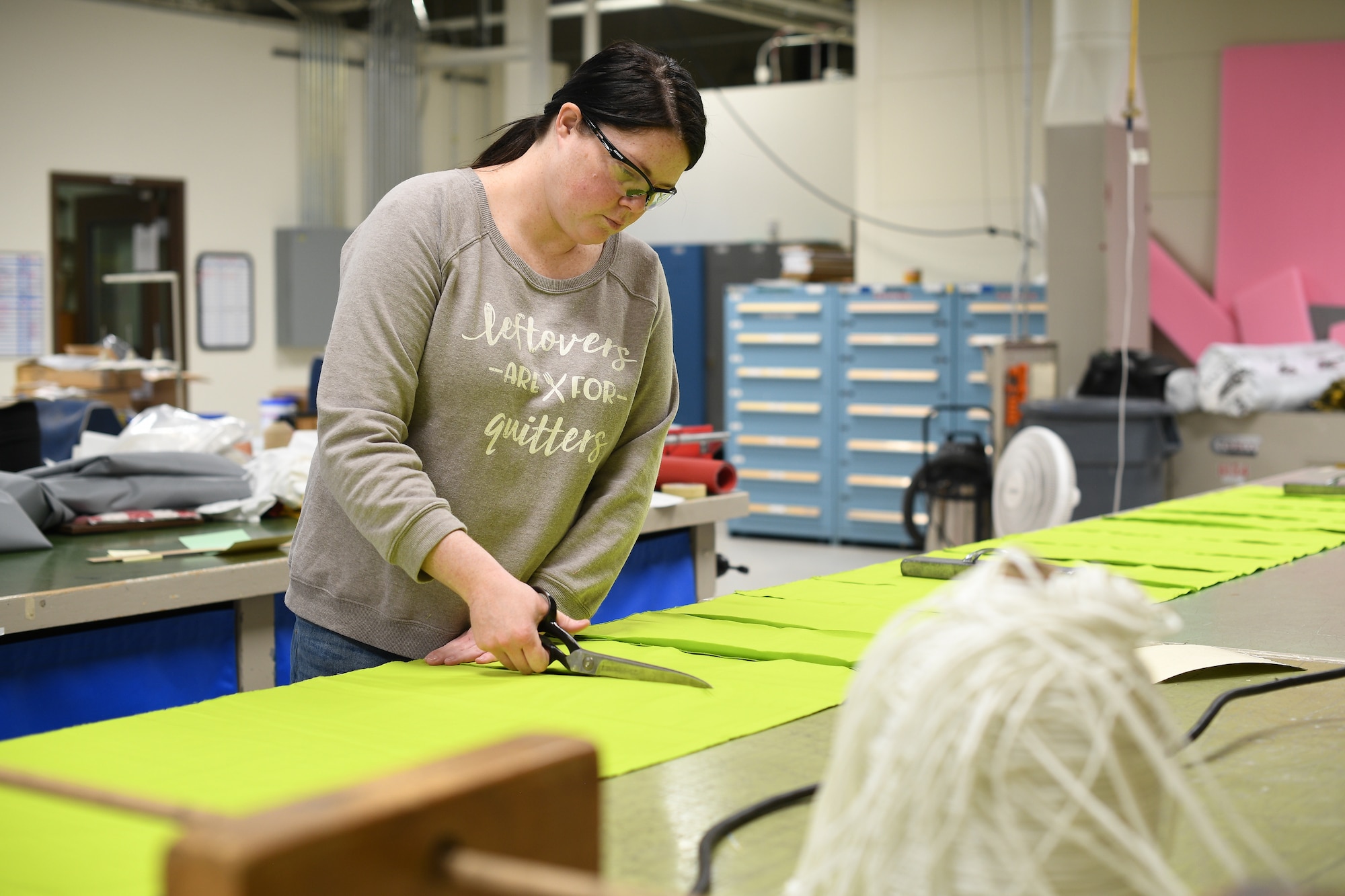 Aircrew Flight Equipment technicians with the 531st Armament Textile Shop make protective cloth masks at Hill Air Force Base, Utah, April 15, 2020. The shop is using their skill set and equipment to produce cloth face coverings for members of Team Hill. (U.S. Air Force photo by R. Nial Bradshaw)