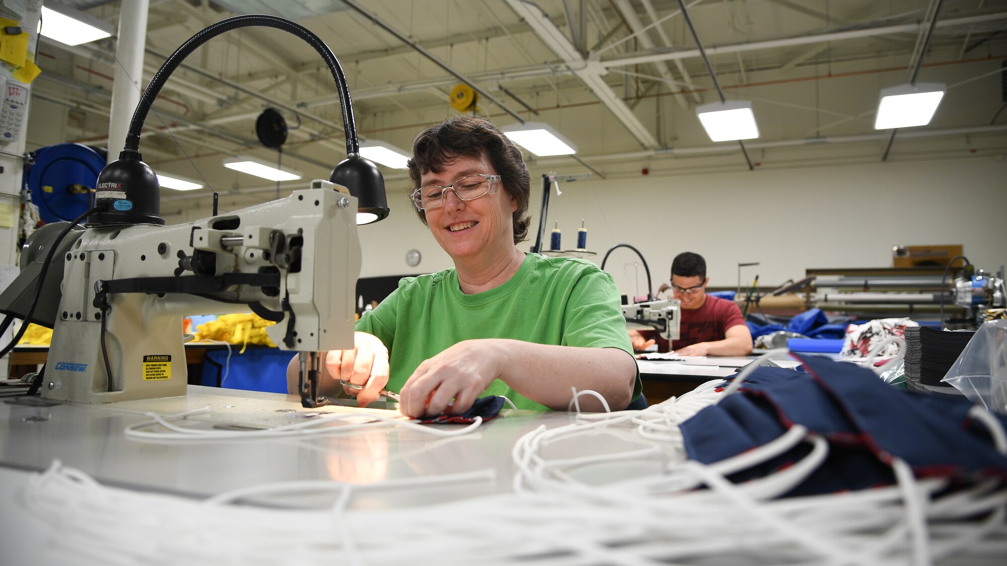 Aircrew Flight Equipment technicians with the 531st Armament Textile Shop make protective cloth masks at Hill Air Force Base, Utah, April 15, 2020. The shop is using their skill set and equipment to produce cloth face coverings for members of Team Hill. (U.S. Air Force photo by R. Nial Bradshaw)