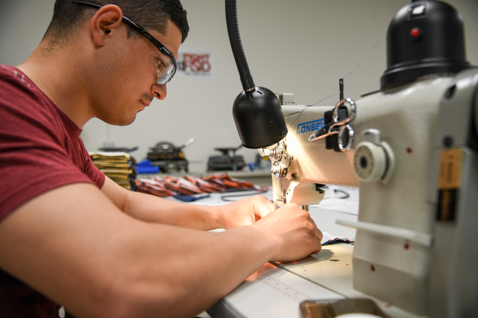 Aircrew Flight Equipment technicians with the 531st Armament Textile Shop make protective cloth masks at Hill Air Force Base, Utah, April 15, 2020. The shop is using their skill set and equipment to produce cloth face coverings for members of Team Hill. (U.S. Air Force photo by R. Nial Bradshaw)