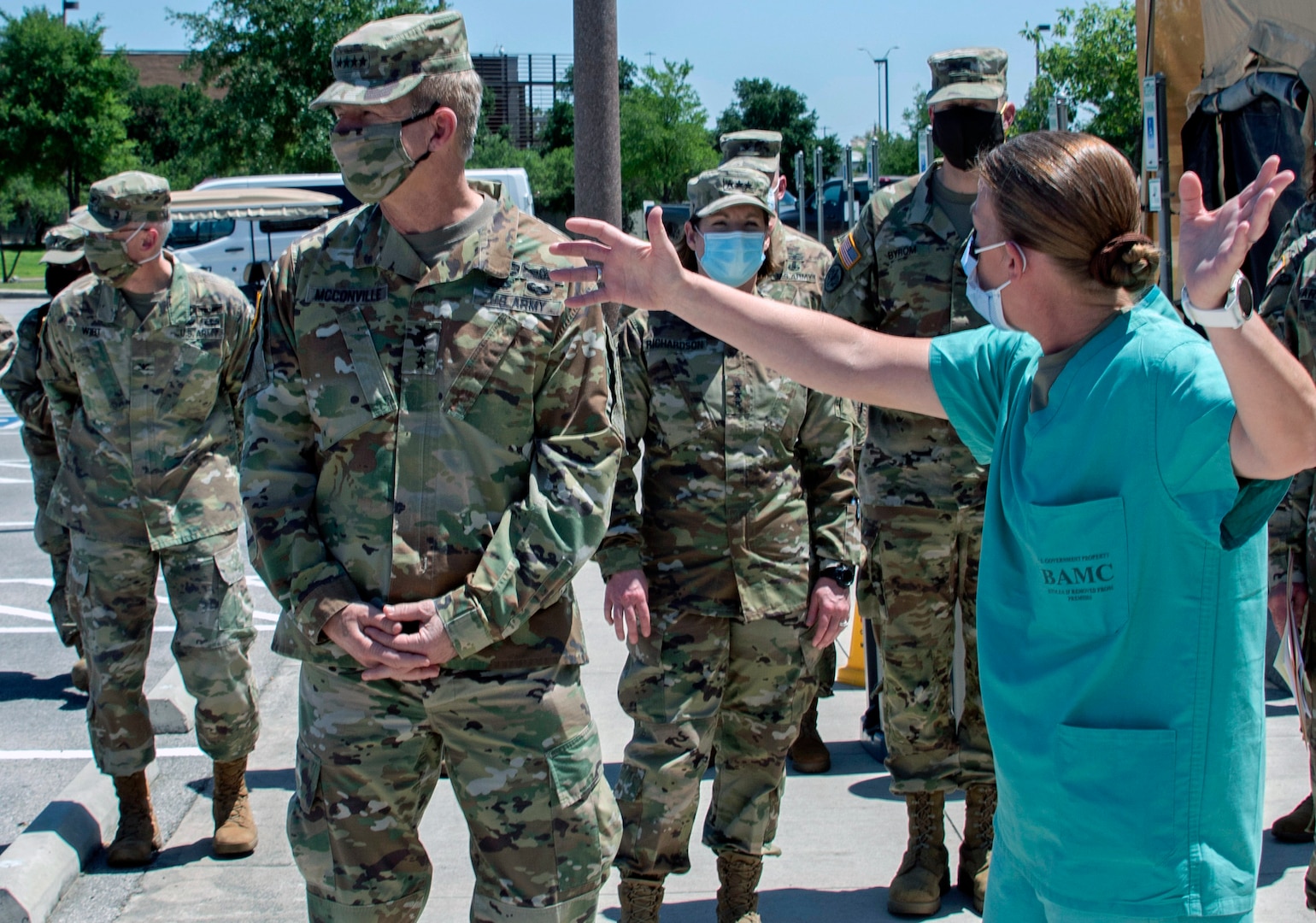 briefs Gen. James McConville, Chief of Staff of the Army, on COVID-19 screening operations at BAMC at  Joint Base San Antonio-Fort Sam Houston April 23. McConville visited BAMC during his tour of Joint Base San Antonio.