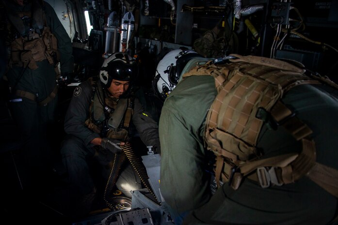 U.S. Marines with Marine Medium Tiltrotor Squadron 268 load a GAU-17A during defensive weapon system training aboard an MV-22B Osprey, Apr. 23, 2020. The DWS is remotely operated and incoporates a gunner station, targeting sensor and the GAU-17 minigun. Designed to provide suppressive defensive fire, proficiency with this weapon system increases the readiness for the Marines of VMM-268. (U.S. Marine Corps photo by Cpl. Matthew Kirk)