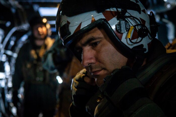 U.S. Marine Corps Lt. Col. Richard Alvarez, commanding officer, Marine Medium Tiltrotor Squadron 268, adjusts his helmet during defensive weapon system training aboard an MV-22B Osprey, Apr. 23, 2020. The DWS is remotely operated and incoporates a gunner station, targeting sensor and the GAU-17 minigun. Designed to provide suppressive defensive fire, proficiency with this weapon system increases the readiness for the Marines of VMM-268. (U.S. Marine Corps photo by Cpl. Matthew Kirk)