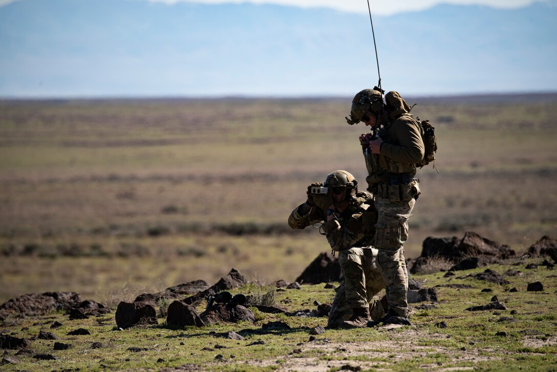 Idaho Air National Guard Joint Terminal Air Controllers look through binoculars, April 17, 2020, at Orchard Combat Training Center, Idaho. JTACs directly communicated with the 391st Fighter Squadron pilots; telling them where to drop live munitions. (U.S. Air Force photo by Airman Natalie Rubenak).